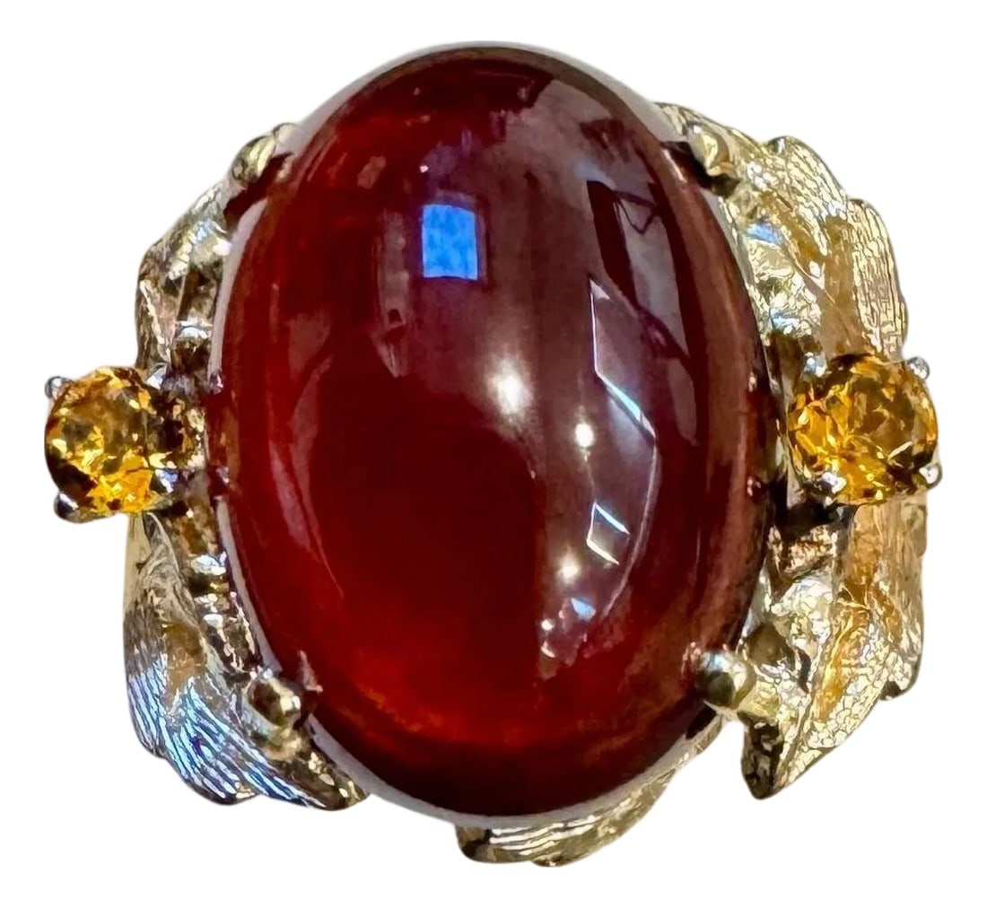10.5 Carat Oval Garnet Cabochon 14 Karat Yellow Gold Cocktail Ring Vintage: This classic cocktail ring features a stunning oval natural Garnet cabochon with two stones of Citrine stones . The Garnet is 10.5 carats and is estate Piece with no color enhancement. The ring is