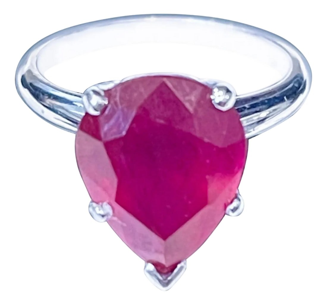 Pear Shape 4.5 Carat Treated Ruby 14 Karat White Gold Ring: 12X10 Pear Cut approximately 4.5 Carat Treated Ruby 14 Karat White Gold Ring Size 5 Its a treated ruby prong set 14 Karat White Gold: 3.9 gram Ring Size 5 ( can be altered for no charge ) Simple ring