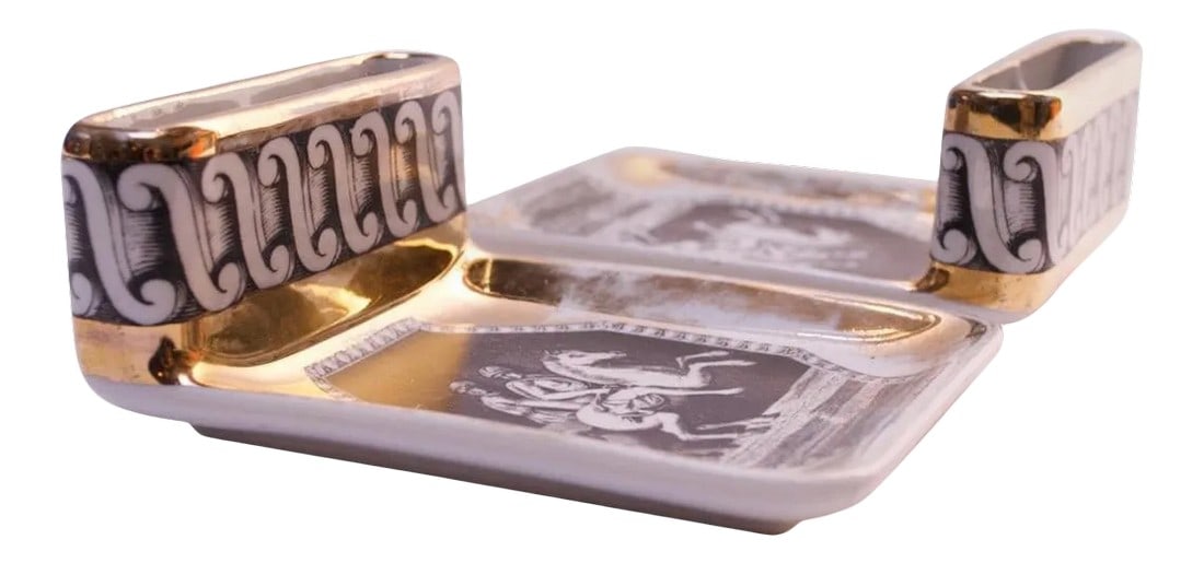 Piero Fornesetti "Equestrian" Ashtrays - A Pair: Pair of ashtrays with cigarette slots by Piero Fornasetti, (circa 1950s, Italy). These examples retailed at Bergdorf Goodman in New York City, as indicated on the reverse. Composed of a grey printed e