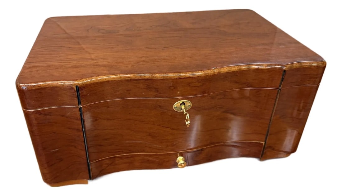 1960s Classic Mahogany Desktop Humidor: This classic cigar humidor features a Spanish cedar–lined interior and traditional brass hardware, offering both function and timeless style. Its clean lines and balanced proportions make it