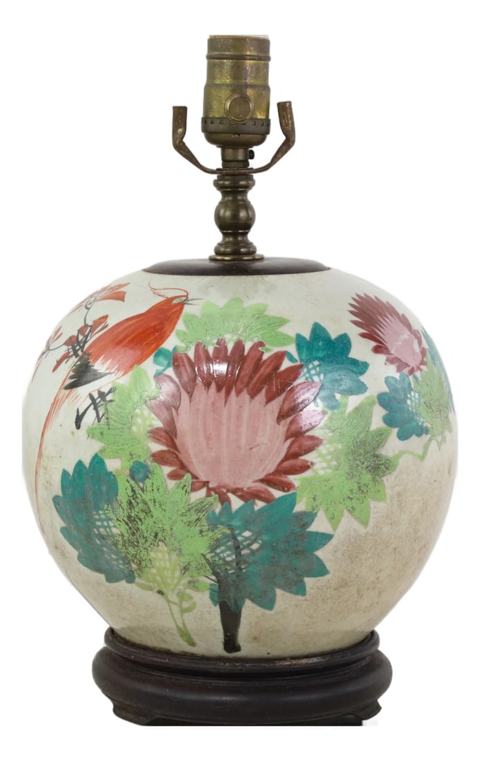Famille Rose Antique Porcelain Vase Lamp With Bird and Floral Motif on Wood Base: This antique table lamp is made with an authentic white porcelain vase featuring a vibrant Famille Rose palette. The rounded, tapered body is decorated with a detailed scene of a red songbird with lon
