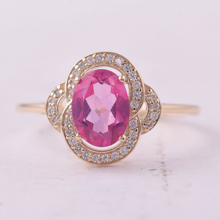 1.48 Ct Oval Pink Topaz 9K Gold Ring: 1.48 Total Carat Pink Topaz 9K Gold Ring Specifications: Total Weight 1.855 g Center Gemstone Pink Topaz Gemstone Carat Weight 1.33 Carats Gemstone Measurements 8X6 mm Additional Gemstones White