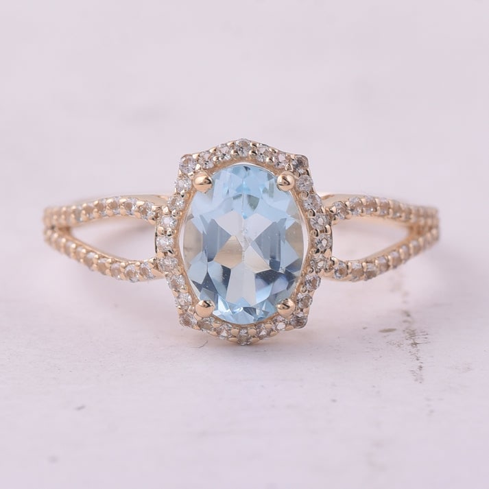 1.80 Ct Oval Blue Topaz 9K Gold Ring: 1.80 Total Carat Blue Topaz 9K Gold Ring Specifications: Total Weight 1.852 g Center Gemstone Blue Topaz Gemstone Carat Weight 1.5 Carats Gemstone Measurements 8X6 mm Additional Gemstones White