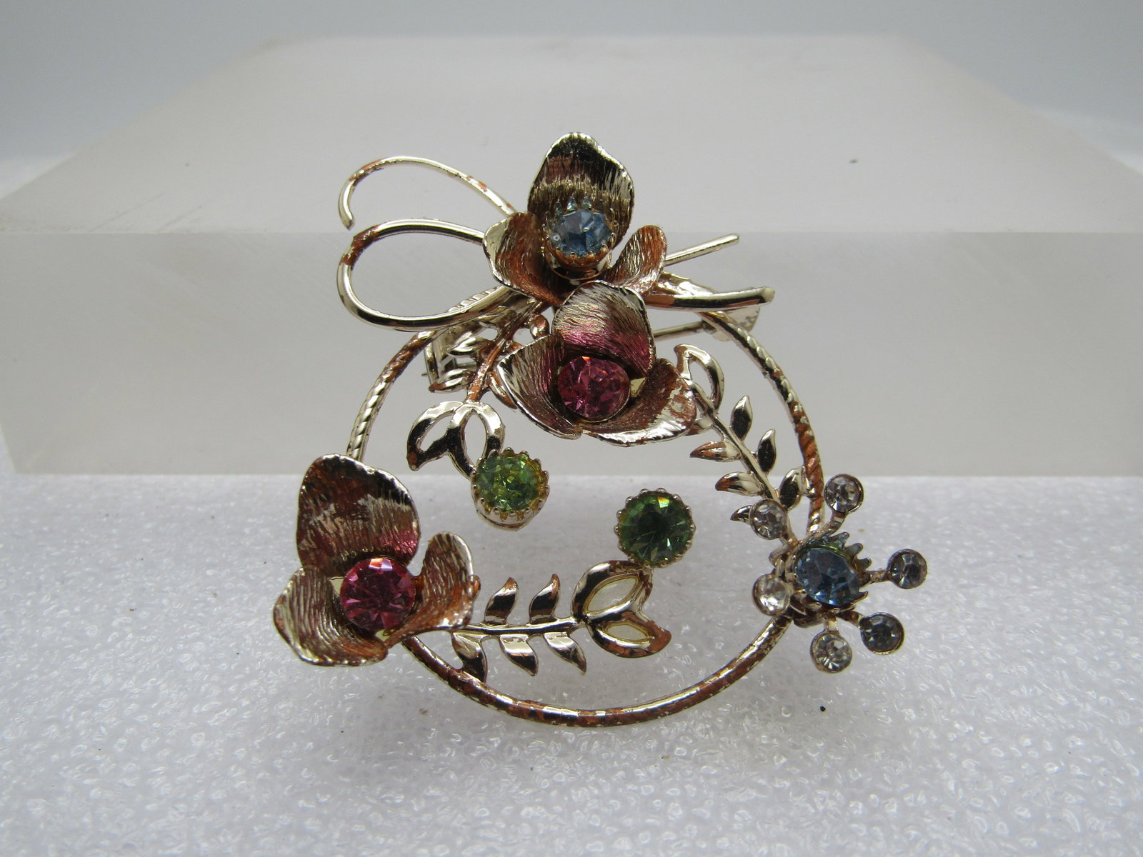 Vintage Rhinestone Floral Circle Brooch, Pastel, 1960's: Title: Vintage Rhinestone Floral Circle Brooch, Pastel, 1960's Description: Vintage Rhinestone Floral Circle Brooch, Pastel, 1960's. It is appx. 1.75" tall and 1.5" wide with raised cup blossoms with 