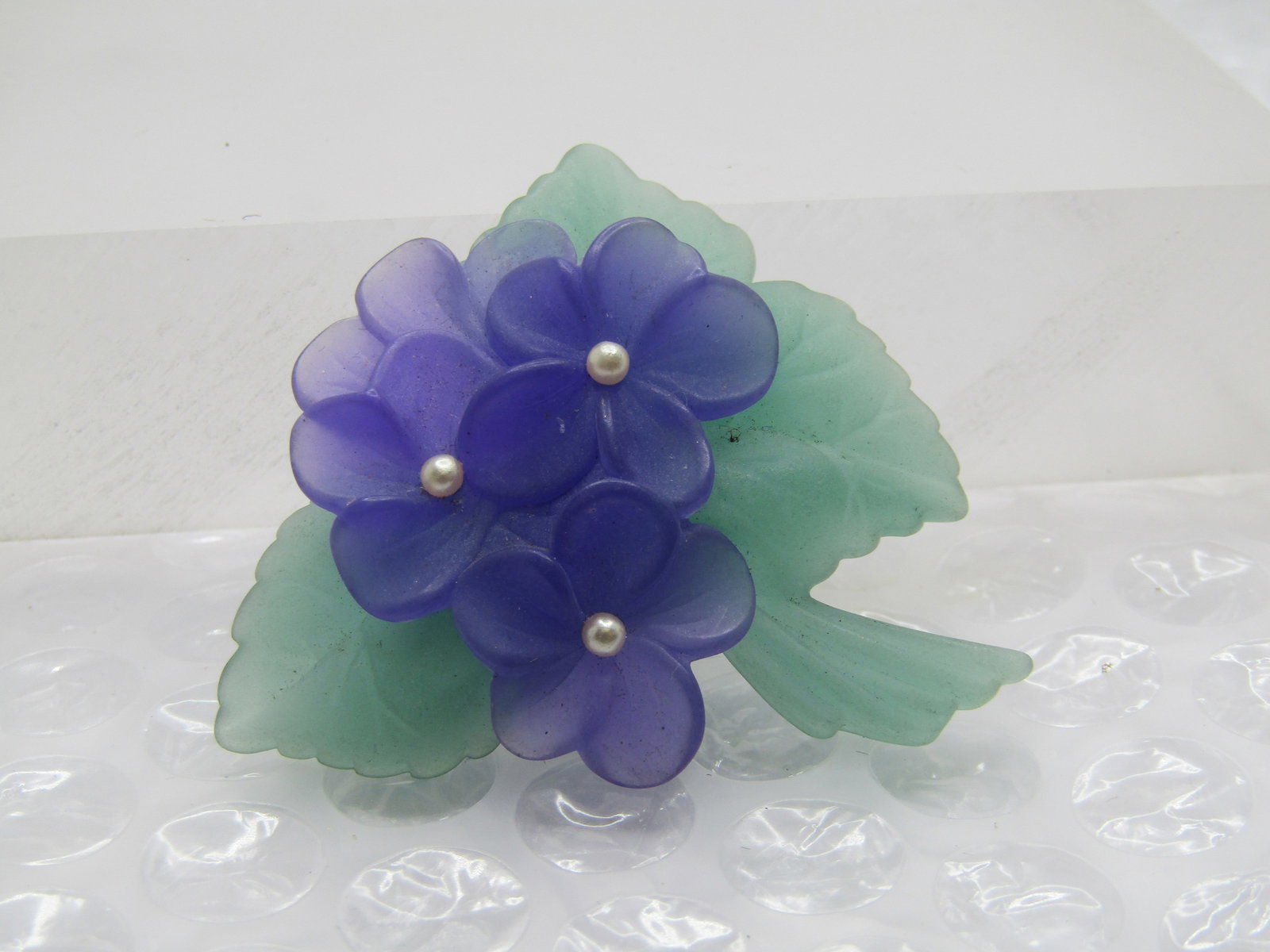 Vintage Avon Violets Brooch, 2" by 1.75", 1970's-1980's: Title: Vintage Avon Violets Brooch, 2" by 1.75", 1970's-1980's Description: Vintage Avon Violets Brooch, 2" by 1.75", 1970's-1980's. Signed Avon. Each of the full three blossoms you see have a seed pe