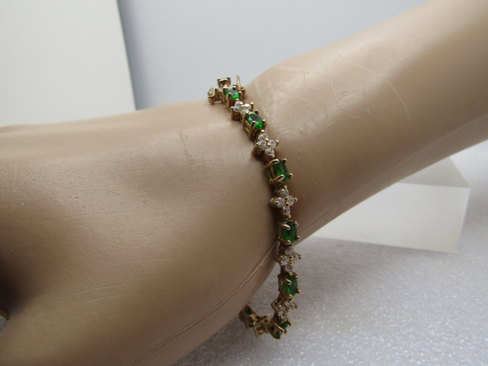 Vintage Gold Over Sterling Green & Clear CZ Tennis Bracelet, 7", 1990's: Title: Vintage Gold Over Sterling Green & Clear CZ Tennis Bracelet, 7", 1990's Description: Vintage Gold Over Sterling Green & Clear CZ Tennis Bracelet, 7", 1990's. It has four clear CZs arranged in a