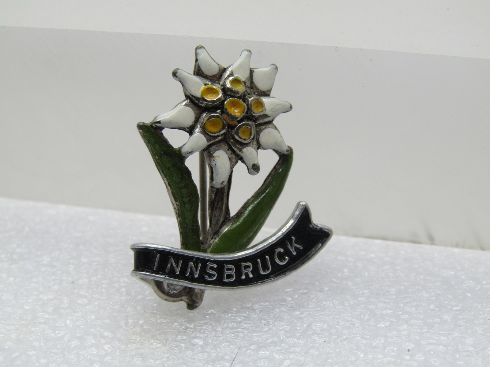 Vintage Innsbruck Edelweiss Enameled Brooch, 1960's: Title: Vintage Innsbruck Edelweiss Enameled Brooch, 1960's Description: Vintage Innsbruck Edelweiss Enameled Brooch, 1960's. Silver tone with a white and yellow enameled blossom and long green leaves 