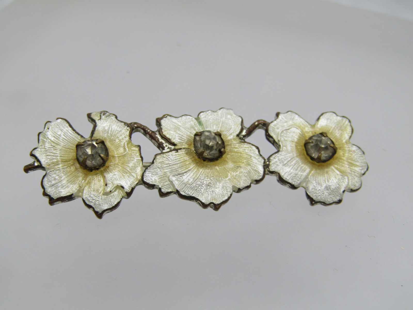 Vintage Guilloche Triple Blossom Brooch, Rhinestones, 2" - C-Clasp: Title: Vintage Guilloche Triple Blossom Brooch, Rhinestones, 2" - C-Clasp Description: Vintage Guilloche Triple Blossom Brooch, Rhinestones, 2" wide and 5/8" tall - C-Clasp. This has a pointed c-clasp
