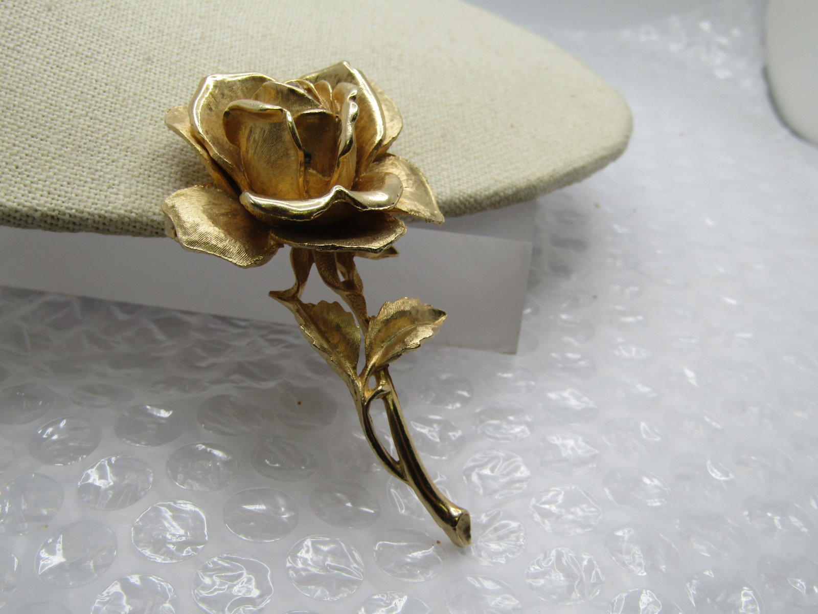Vintage Gold Tone Rose Brooch, Single Rhinestone, 3": Title: Vintage Gold Tone Rose Brooch, Single Rhinestone, 3" Description: Vintage Gold Tone Rose Brooch, Single Rhinestone, 3" tall textured inish rose bud blossom with two leaves in a mix of textured 