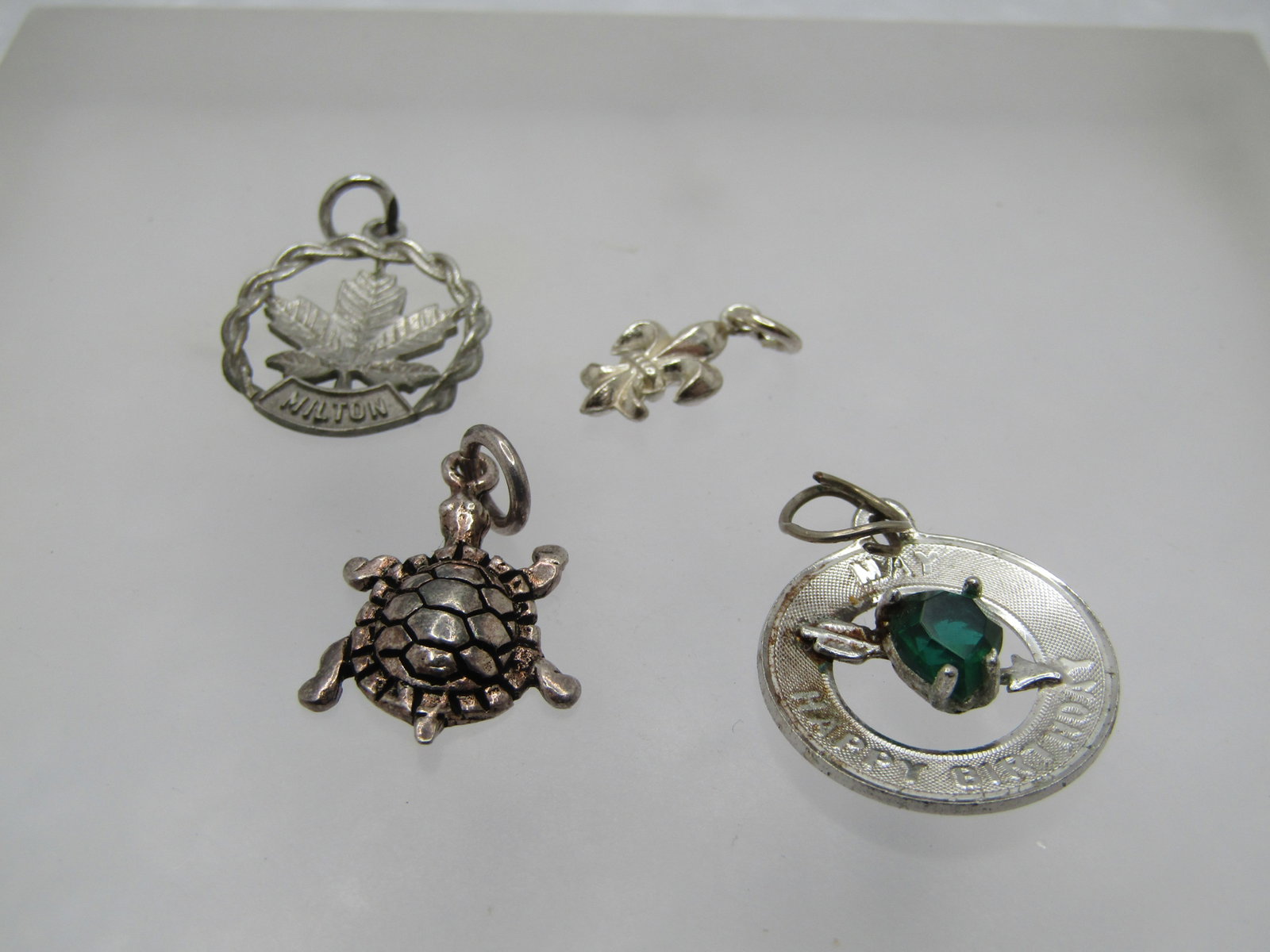 Vintage Four Sterling Charms, Turtle; Fleur-de-Lis; May Birthday; Maple Leaf, 1960's-1980's (1 of 4)
