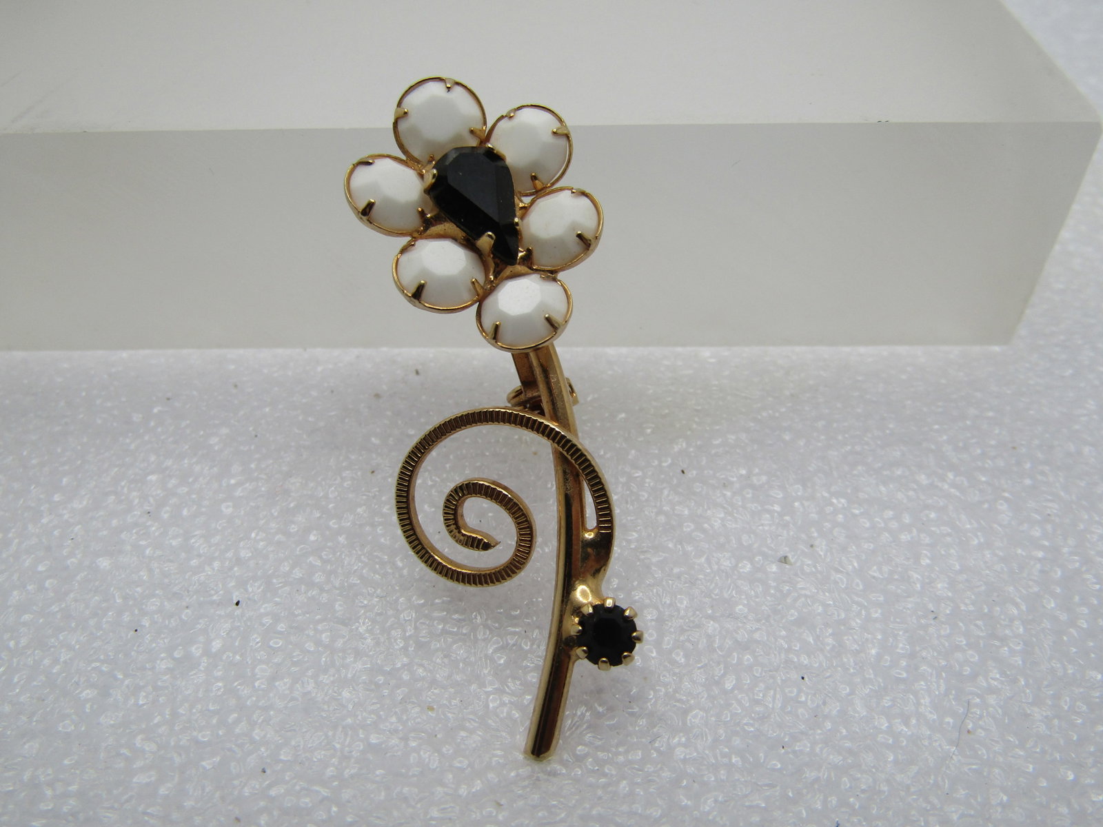 Vintage White & Black Floral Stem Brooch, 1960's: Title: Vintage White & Black Floral Stem Brooch, 1960's Description: Vintage White & Black Floral Stem Brooch, 1960's. Round white glass stones make up the petals and the center is a tear-drop black g