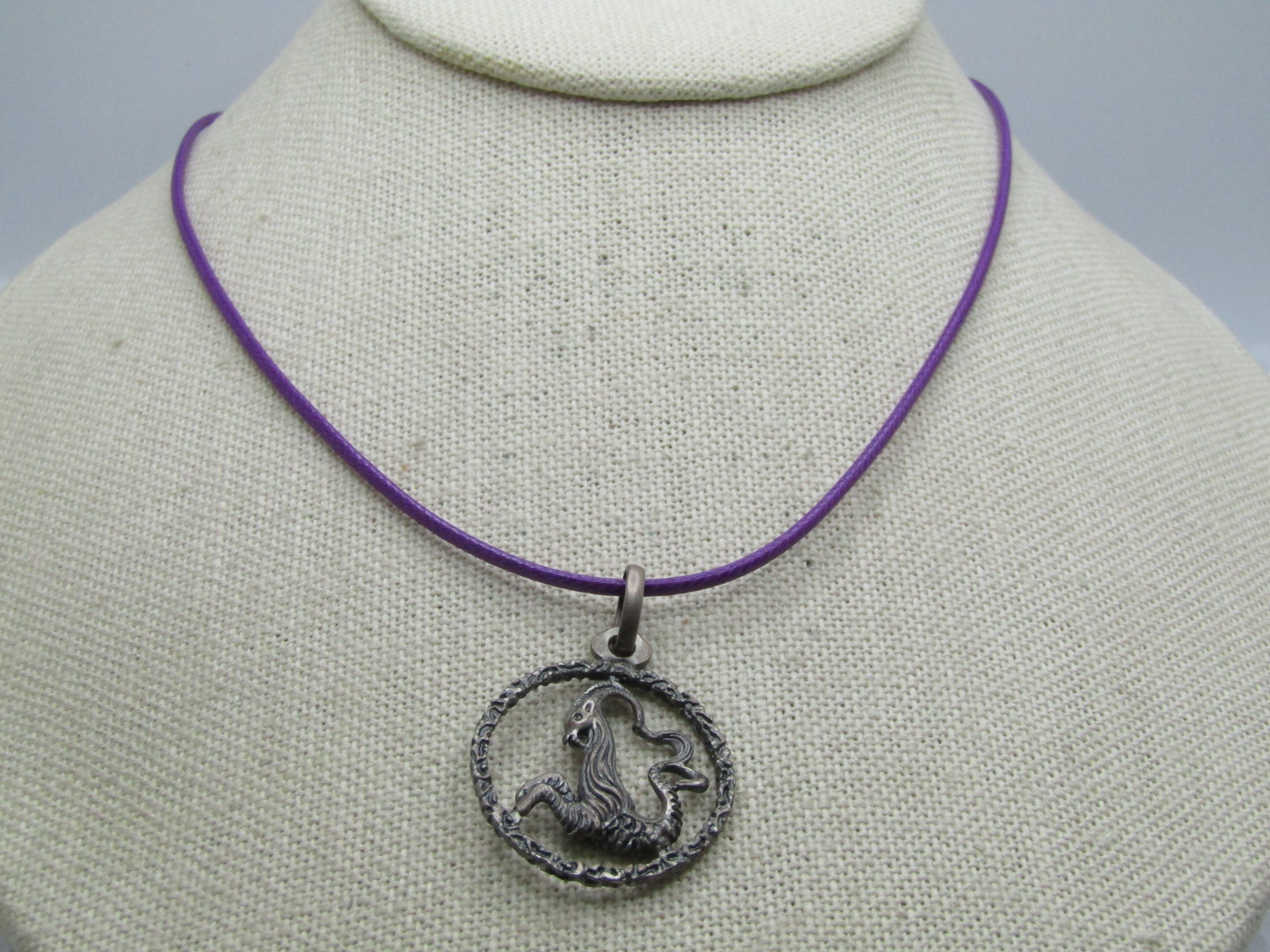 Vintage Sterling Capricorn Goat Necklace, 20", Signed Unoaerre: Title: Vintage Sterling Capricorn Goat Necklace, 20", Signed Unoaerre Description: Vintage Sterling Capricorn Goat Necklace, 20", Signed Unoaerre (Italian), 1960's-1970's. This is on a 20" purple lami