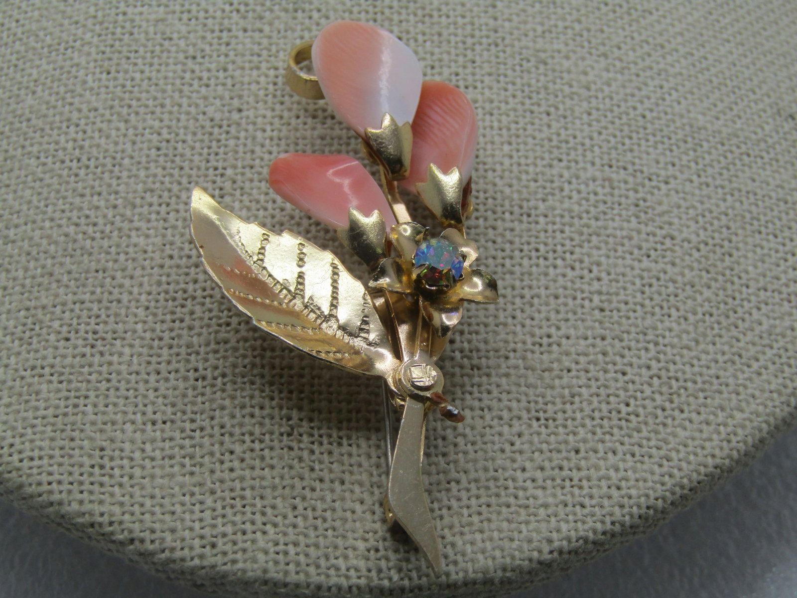 Vintage Shell & Rhinestone Stem Brooch, 1960's-1970's, 2": Title: Vintage Shell & Rhinestone Stem Brooch, 1960's-1970's, 2" Description: Vintage Shell & Rhinestone Stem Brooch, 1960's-1970's, 2" by 1.25" wide. It has a smooth stem with curved leaf and three p