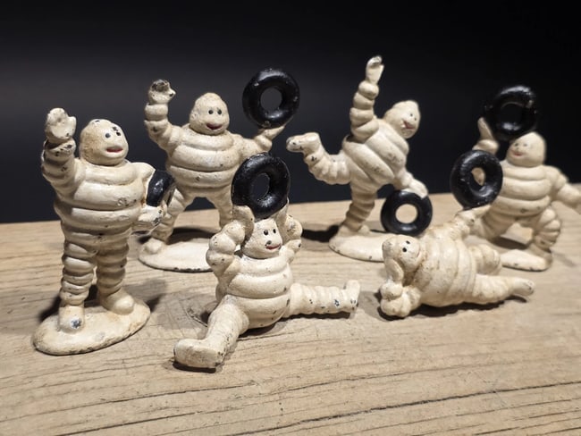Cast Iron Set of 6 Michelin Men ? Classic Advertising: Set of 6 Michelin men, one of the earliest and most recognizable advertising mascots of the 20th century. Rendered here in playful, animated poses, they reflect the lighthearted promotional style Mich