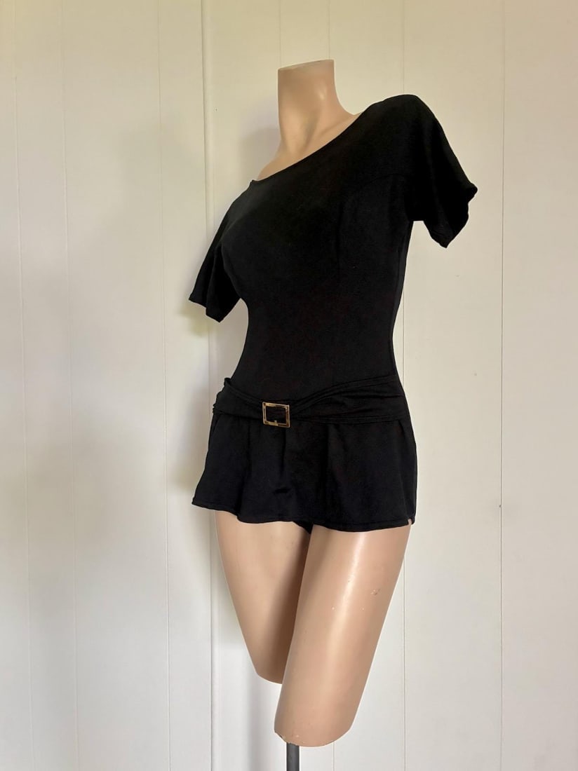 Vintage 1960s Black One Piece Swimsuit Bathing Suit Cole of California Sz M: Black Thick nylon Short sleeves One piece shorts style Mid 1960s With decorative belt Scoop back Built-in bra Slightly pointy Panty/skirt bottom Built in liner Size: M, up to approx. US10-12. Please