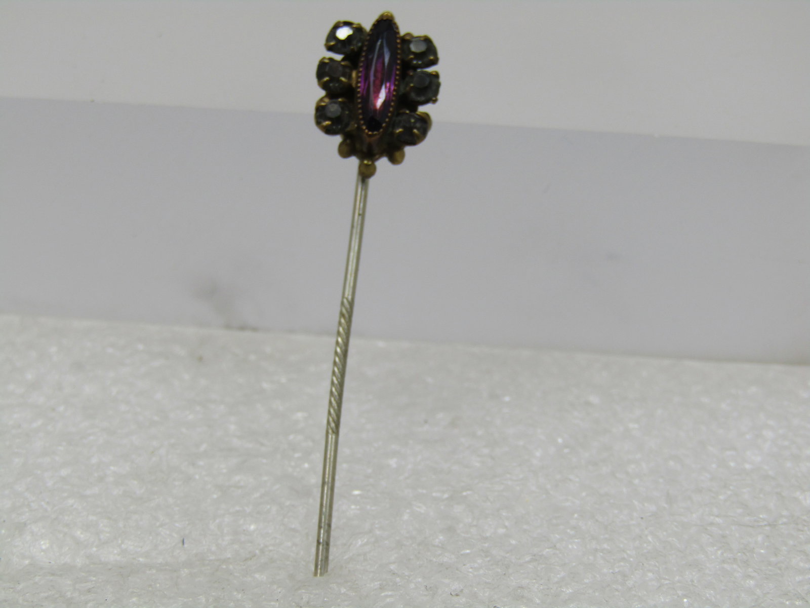 Antique Rhinestone Stick Pin, Purple/Clear, early 1900's: Antique Rhinestone Stick Pin, Purple/Clear, 1800's-1900's. 2.5" long with a pin that has the textured center for non-slippage when wearing. This has a narly 5/8" long toppr with a center amethyst colo
