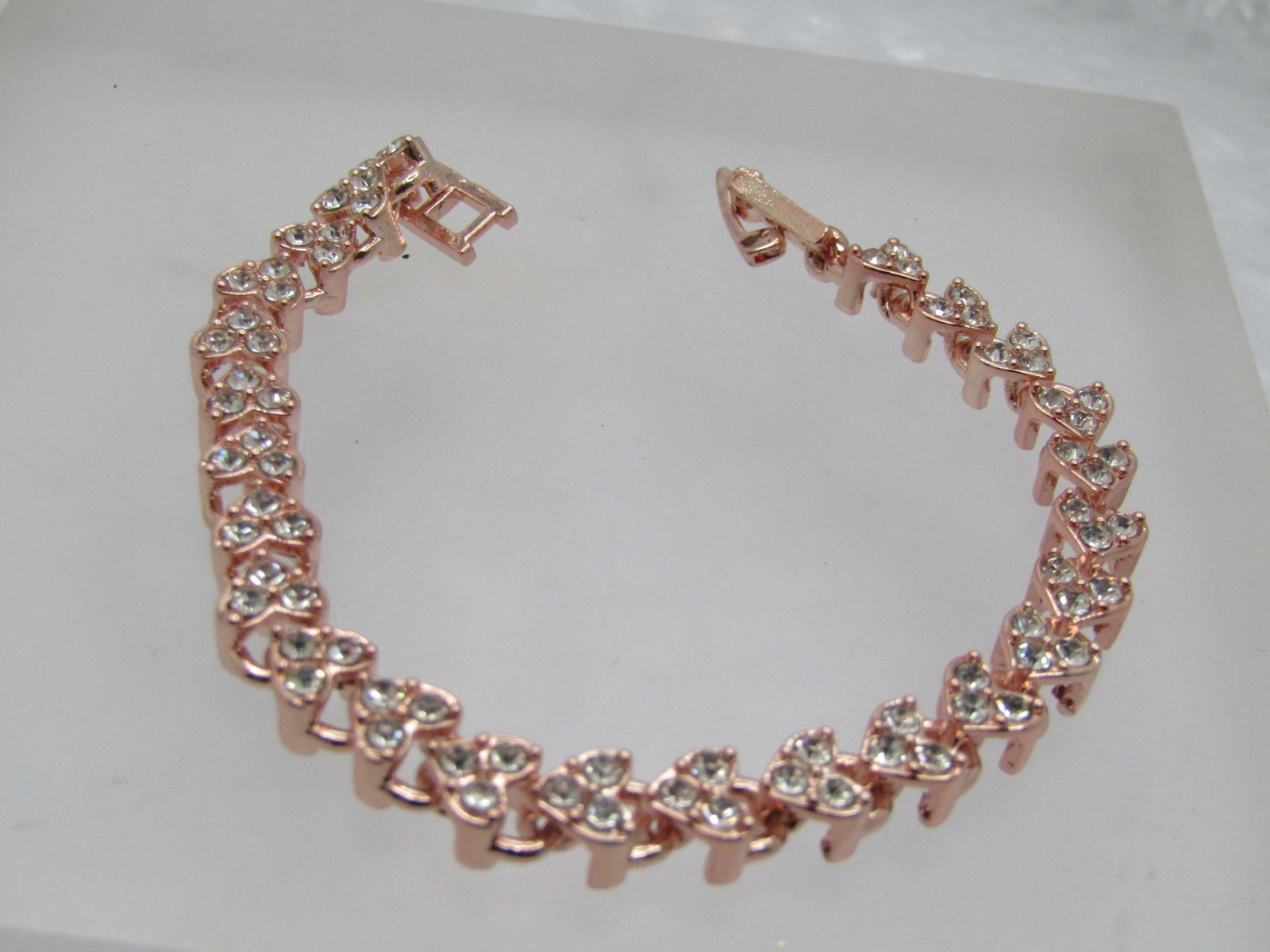 Costume Rhinestone Heart Bracelet, 7" and 6mm, 2000's: Costume Rhinestone Heart Bracelet, 7" and 6mm, 2000's, Flip Gold tone and earh link has three clear rhinestones in what looks like a heart-shaped lock. It is not signed or marked. Cute bracelet but