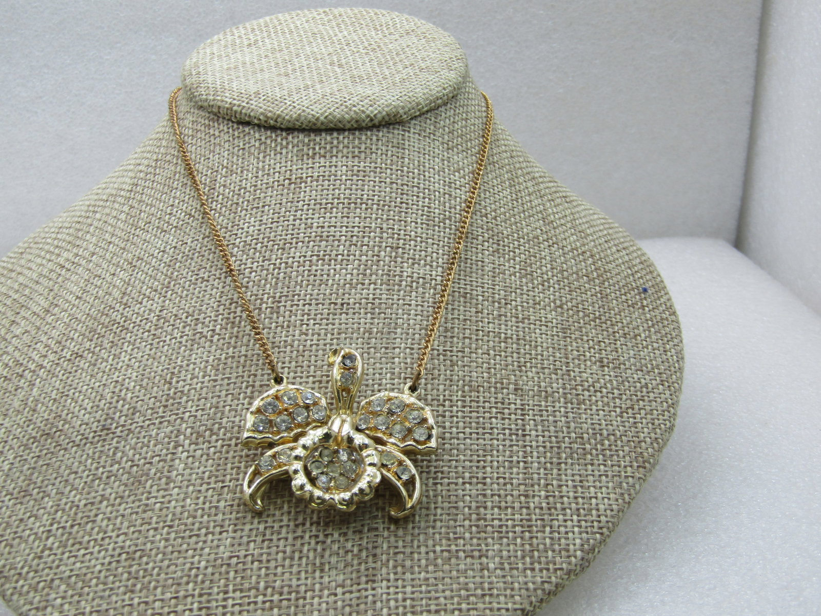 Vintage Rhinestone Orchid Brooch, 1960's 15": Vintage Rhinestone Orchid Brooch, 1960's 15" An orchid pendant with pave-set rhinestones in all sections. Good condition with some light wear. All stones present one stone at top center is slightly da