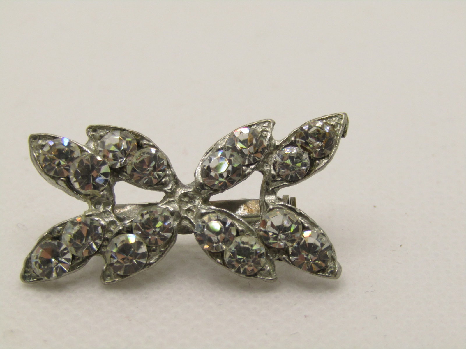 Vintage Art Deco Rhinestone Brooch, 1.25" Pointed Design: Vintage Art Deco Rhinestone Brooch, 1.25" wide and 3/4" tall. Pointed Design with two round rhienstones set in a pointed setting giving it the look of marquise stones. Not signed by the maker. Age is 