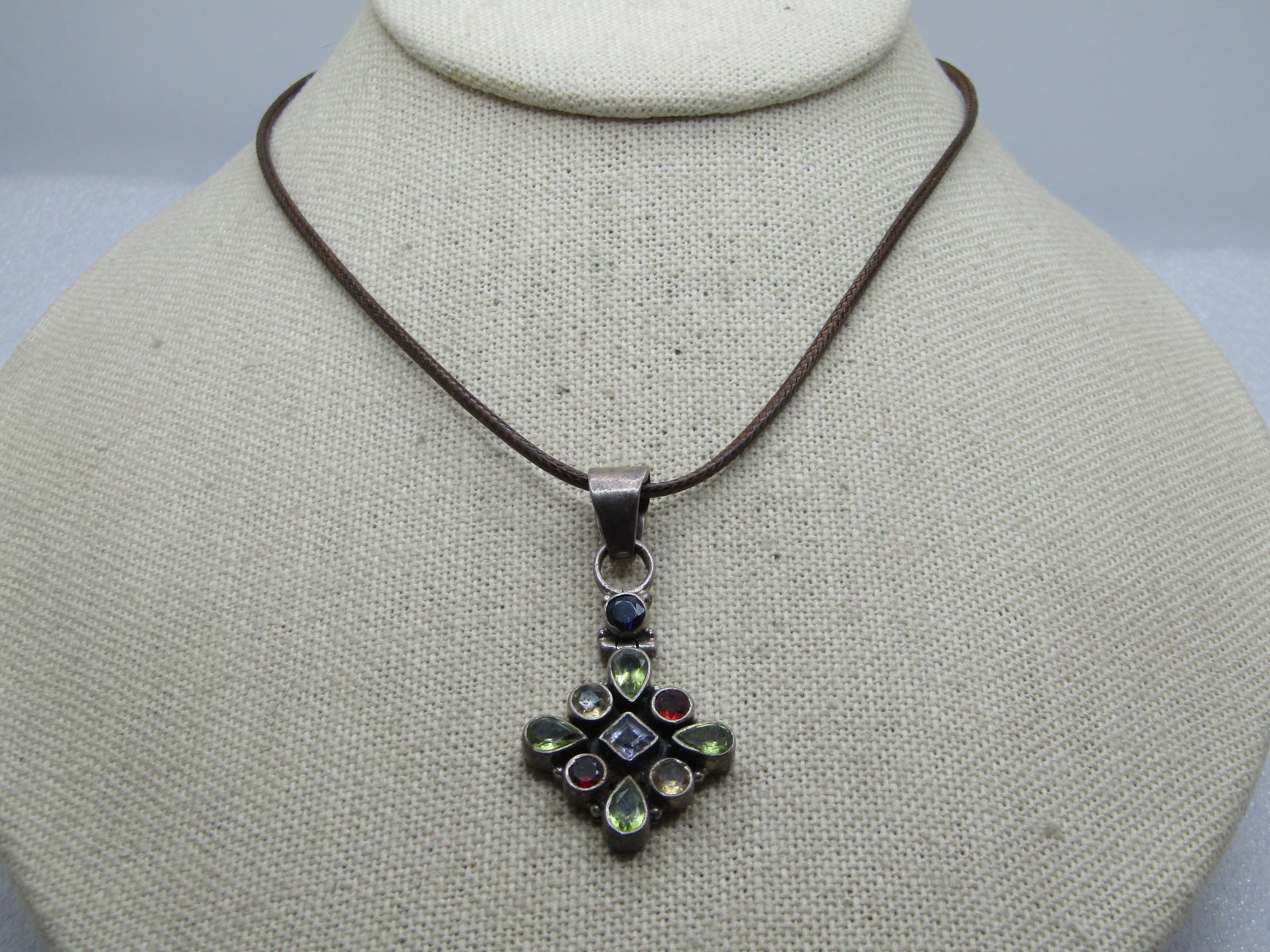 Vintage Sterling Mixed Gem Necklace, 20", 1980's-1990's: Vintage Sterling Mixed Gem Necklace, 20", 1980's-1990's. The pendant is marked sterling and has a wide swing bail with a hinged top and nine stones in the bottom of the pendant: four pear-shaped perid