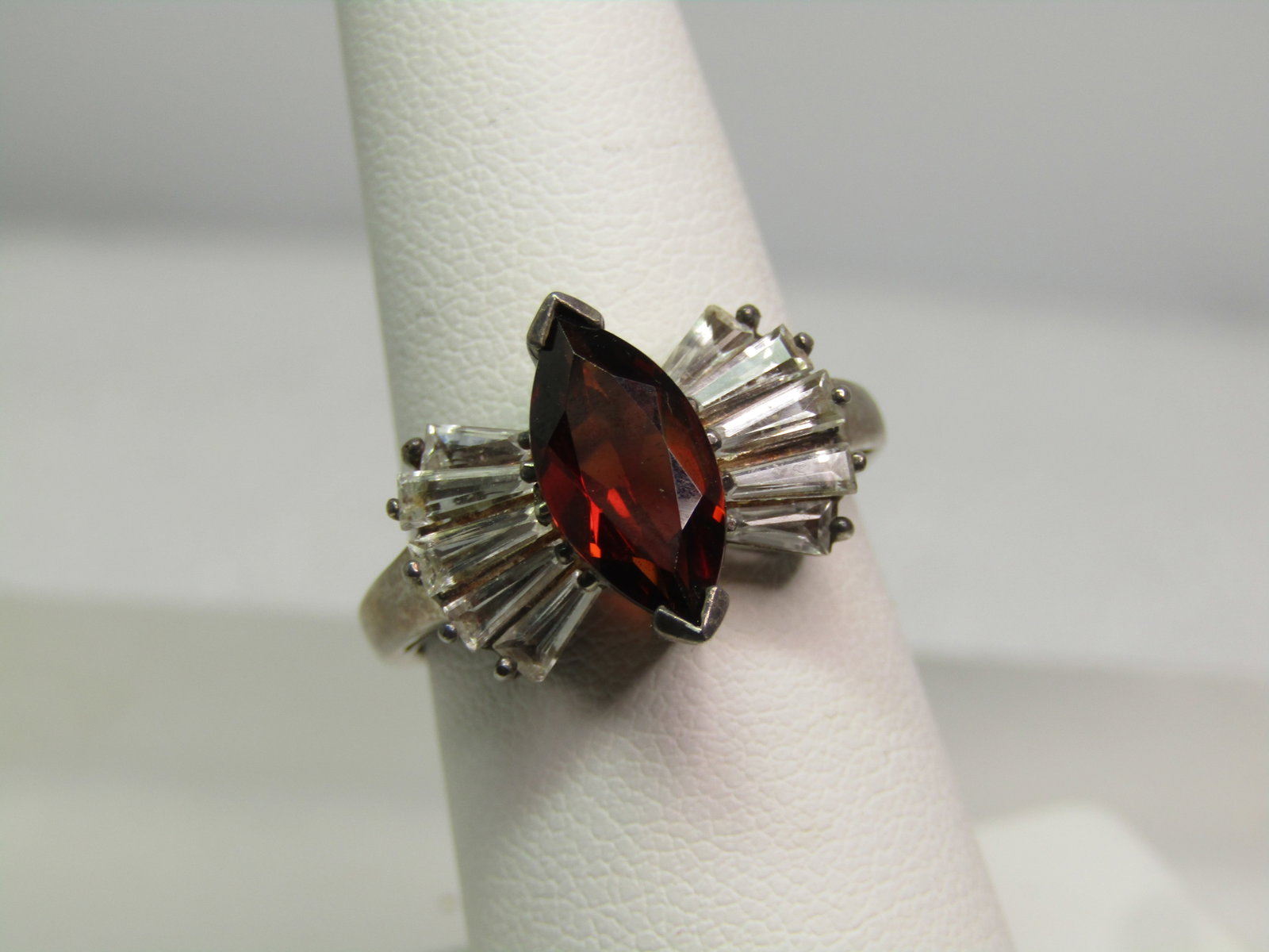 Vintage Sterling Garnet & White Topaz Ring, Sz. 7, 1980's-1990's , Signed: Vintage Sterling Garnet & White Topaz Ring, Sz. 7, 1980's, Signed with what looks like a bird outlined image. It is marked .925 and tests as sterling with an appx. weight of 4.11 grams. The main stone