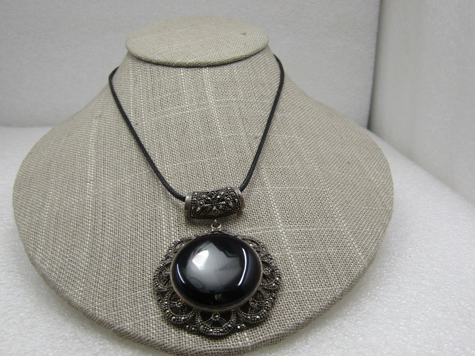 Vintage Sterling Marcasite & Onyx Necklace, 19" Black Leather: Vintage Sterling Marcasite & Onyx Necklace, 19" Black Leather. The black cord is appx. 1mm rou nd and is 17" with 2" extender chain. The pendant is a victorian themed marcasite scalloped frame with a