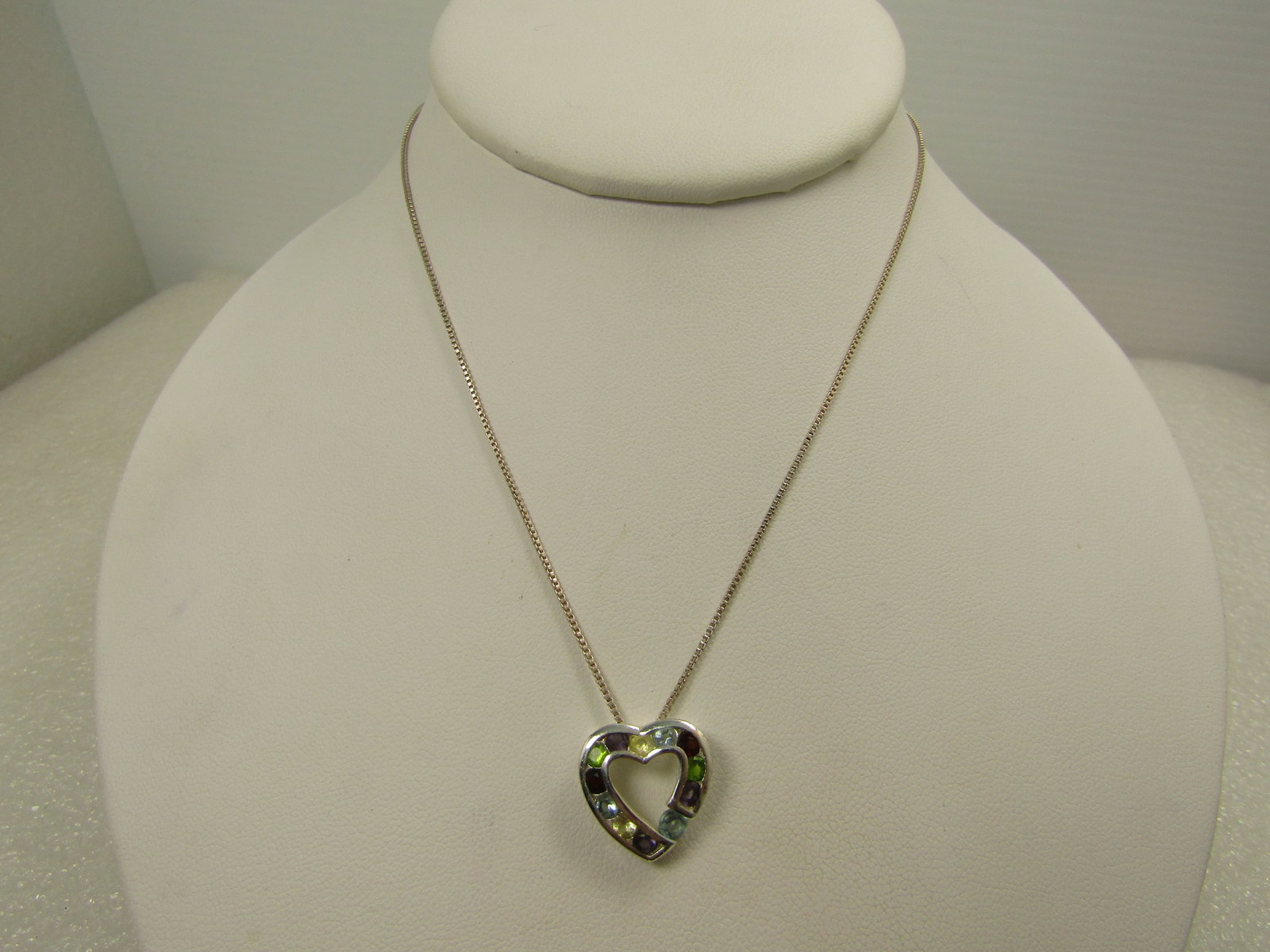 Mixed Rhinestone Heart Necklace, 18", Marked .925: Mixed Rhinestone Heart Necklace, 18", Marked .925. 1980's-1990's. THe pendant is a silver plated heart with red, blue, yellow, green stones - simulated. topaz; citrine; garnet' and peridot. They do no