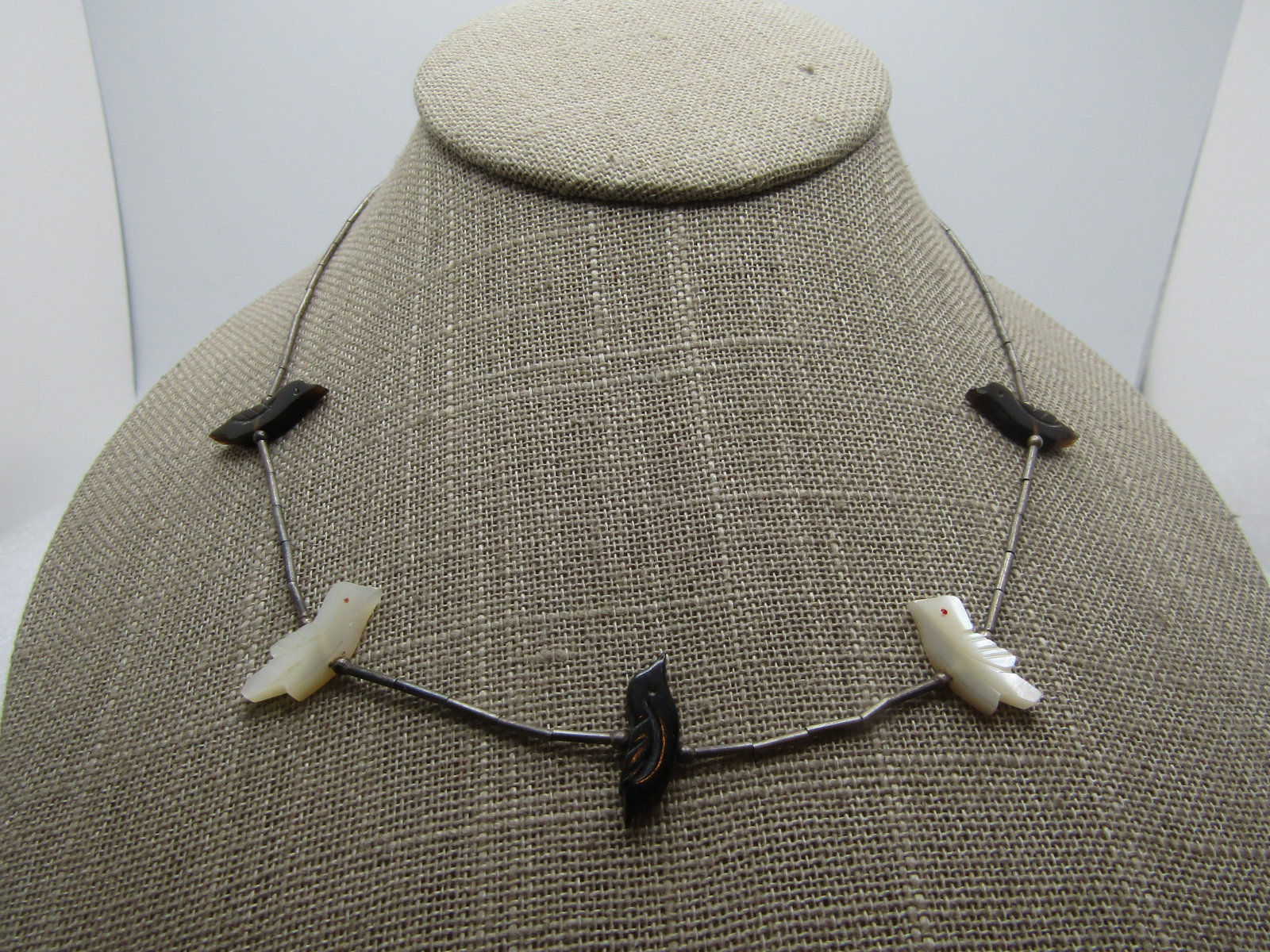 Vintage Sterling Southwestern Bird Fetish Necklace 16", 1960's-1970's: Vintage Sterling Southwestern Bird Fetish Necklace 16", 1960's-1970's. This has three onyx and two mother-of-pearl bird fetishes on a sterling straw bead necklace with hook clasp. It tests as