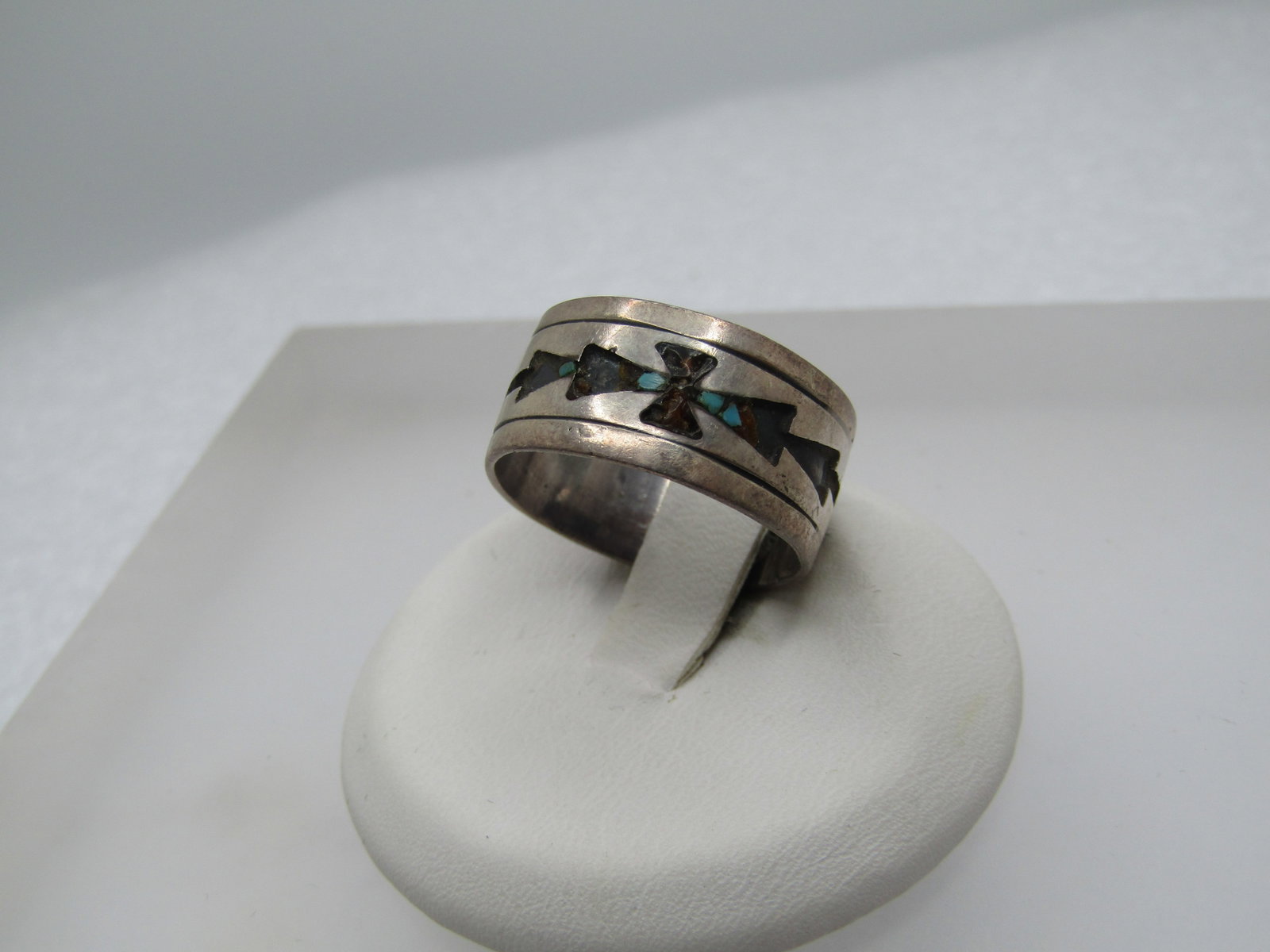 Vintage Sterling Southwestern Inlaid 9mm Band Ring, Sz. 7, Signed, 1960's-1970's: Vintage Sterling Southwestern Inlaid 9mm Band Ring, Sz. 7, Signed T and what looks like a partial C. It has a cross like image in the center with arrow pointing toward in - it had inlaid turquoise and