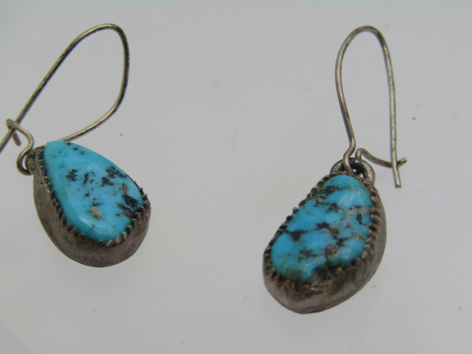 Vintage Sterling Southwestern Turquoise Earrings, Pierced, Drop, 1960's-1970's: Vintage Sterling Southwestern Turquoise Earrings, Pierced, Drop, 1960's-1970's. Locking hook post with a turquoise nugget that is sawtooth bezel-set and appx. 13mm by 8mm. They are appx. 1-1/8" long