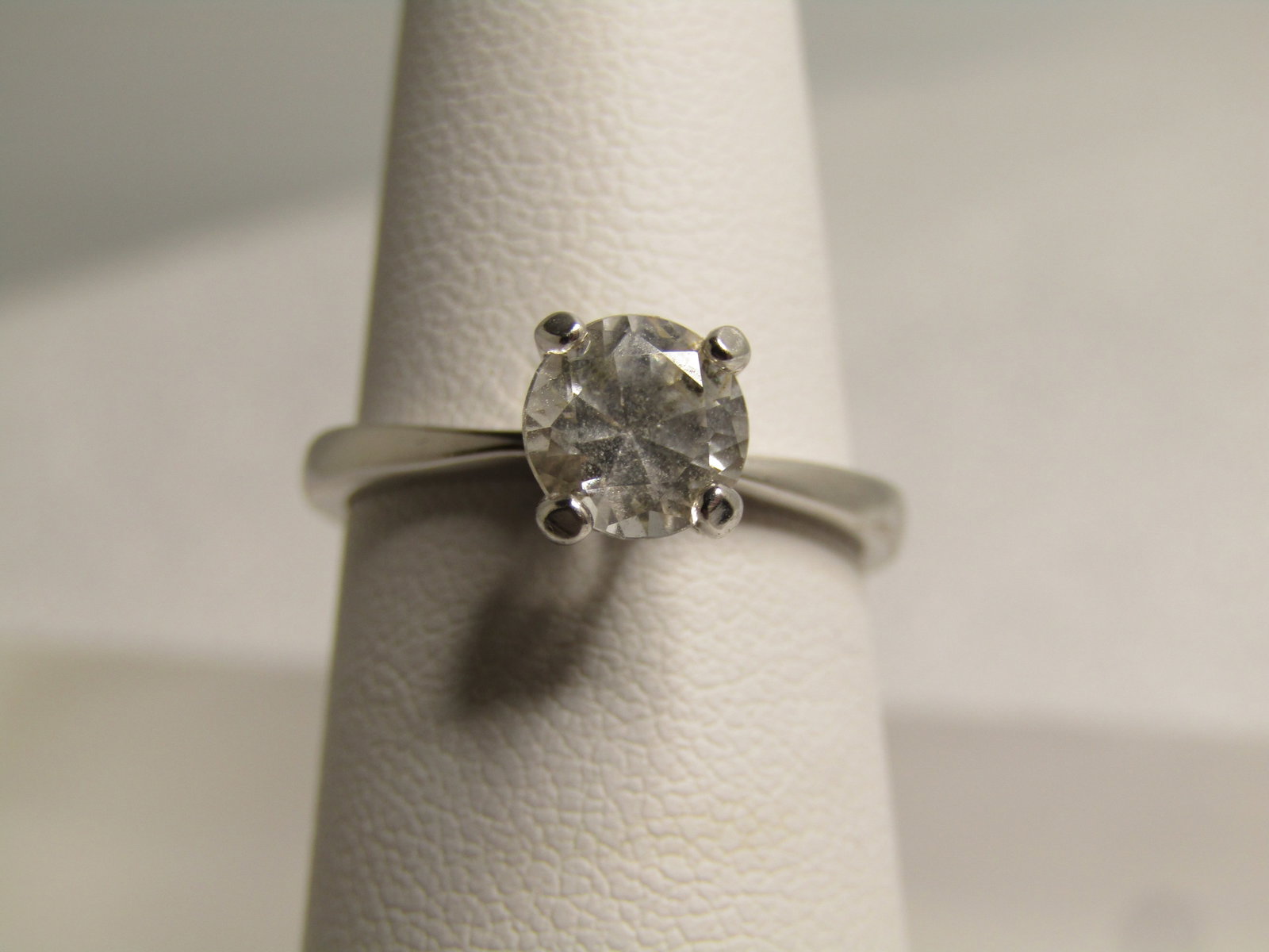 Vintage Sterling White Topaz Engagement Ring, 1 CTW, Sz. 6, 1980's-1990's: Vintage Sterling White Topaz Engagement Ring, 1 CTW, Sz. 6, 1980's-1990's . The stones tests as white topaz and ia appx. 6+ mm across, round cut set with four tall prong. The band is appx. 1.9mm-2.2mm