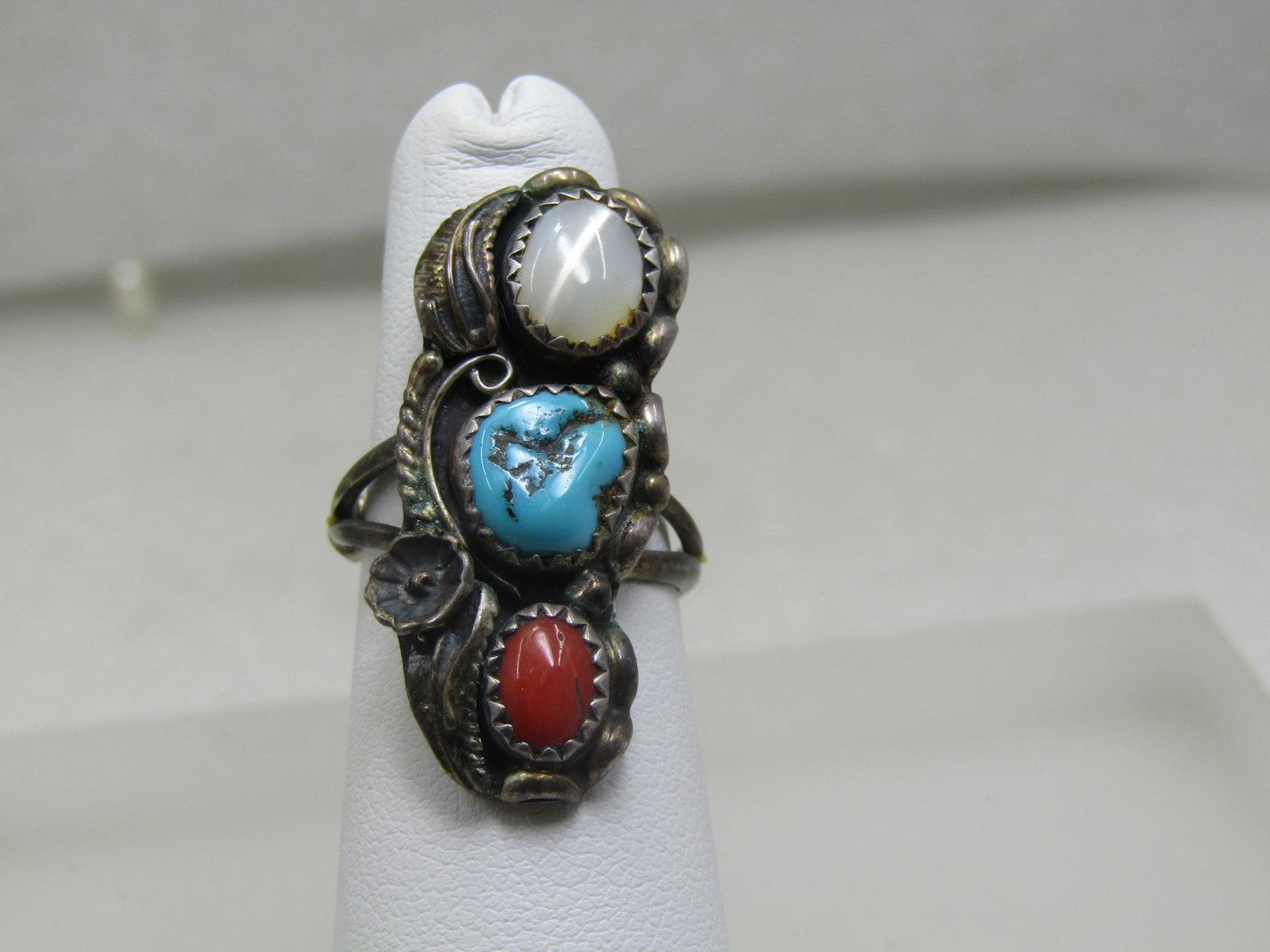 Vintage Sterling Southwestern Turquoise, Coral, MOP Ring, Sz. 6.5: Vintage Sterling Southwestern Turquoise, Coral, MOP Ring, Sz. 6.5, It is a long ring down the finger, appx. 1-3/8" and 1/2" wide to 5/8" wide. It has an oval red coral that is appx. 5mm long and 4mm w