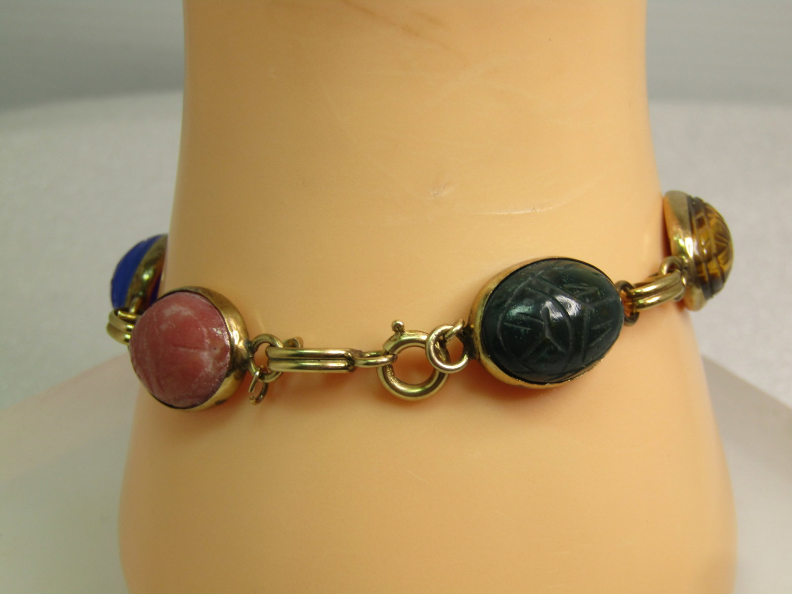Vintage Egyptian Scarab GF Bracelet, 7.5", Unakite, Carnelian, Tiger's Eye, More, 1960's: Vintage Egyptian Scarab GF Bracelet, 7.5", Unakite, Carnelian, Tiger's Eye, More, 1960's. Six stones that are oval with the carved beetle top and carving on the bottom. The stones are appx. 15mm by 12