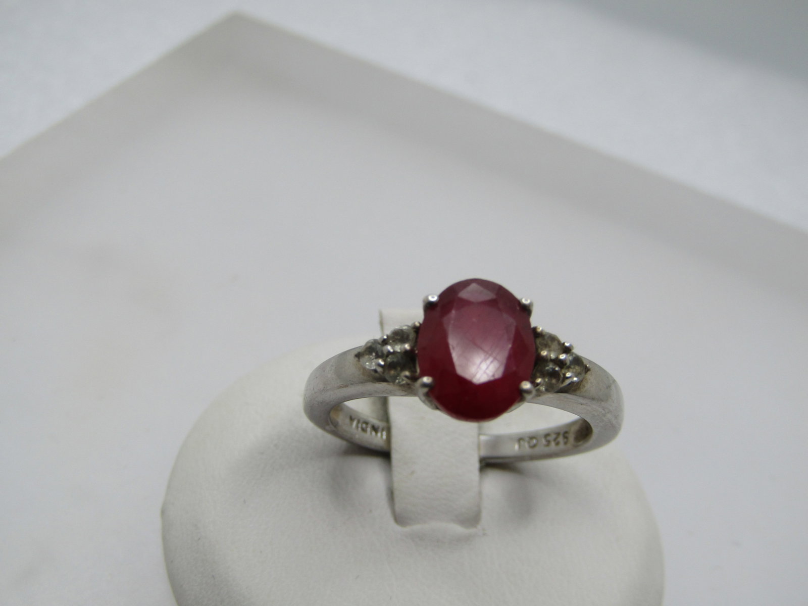 Vintatge Sterling Ruby White Topaz Ring, Sz. 9.25 Signed: Vintatge Sterling Ruby White Topaz Ring, 2 CTW, Sz. 9.25 Signed Q.J. Indian. Marked .925 and tests as sterling with a weight of appx. 3.77 gr. The ruby is oval with three small clear rhinestones that 