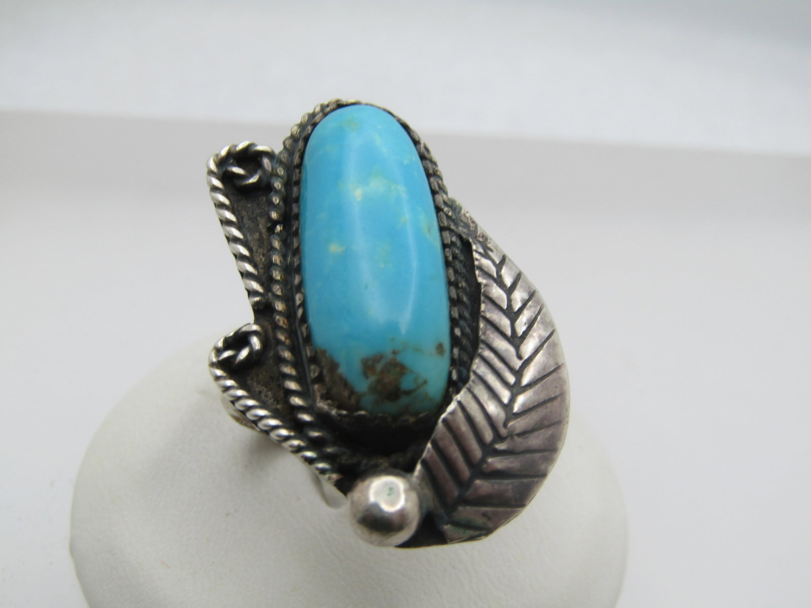 Vintage Sterling Southwestern Turquoise Ring, Sz. 7.5, 1960's-1970's: Vintage Sterling Southwestern Turquoise Ring, Sz. 7.5, 1960's-1970's. This is a 1.25" long ring down the finger and appx. 7/8" across the finger. It has a long oval sawtooth bezel-set turquoise stone 