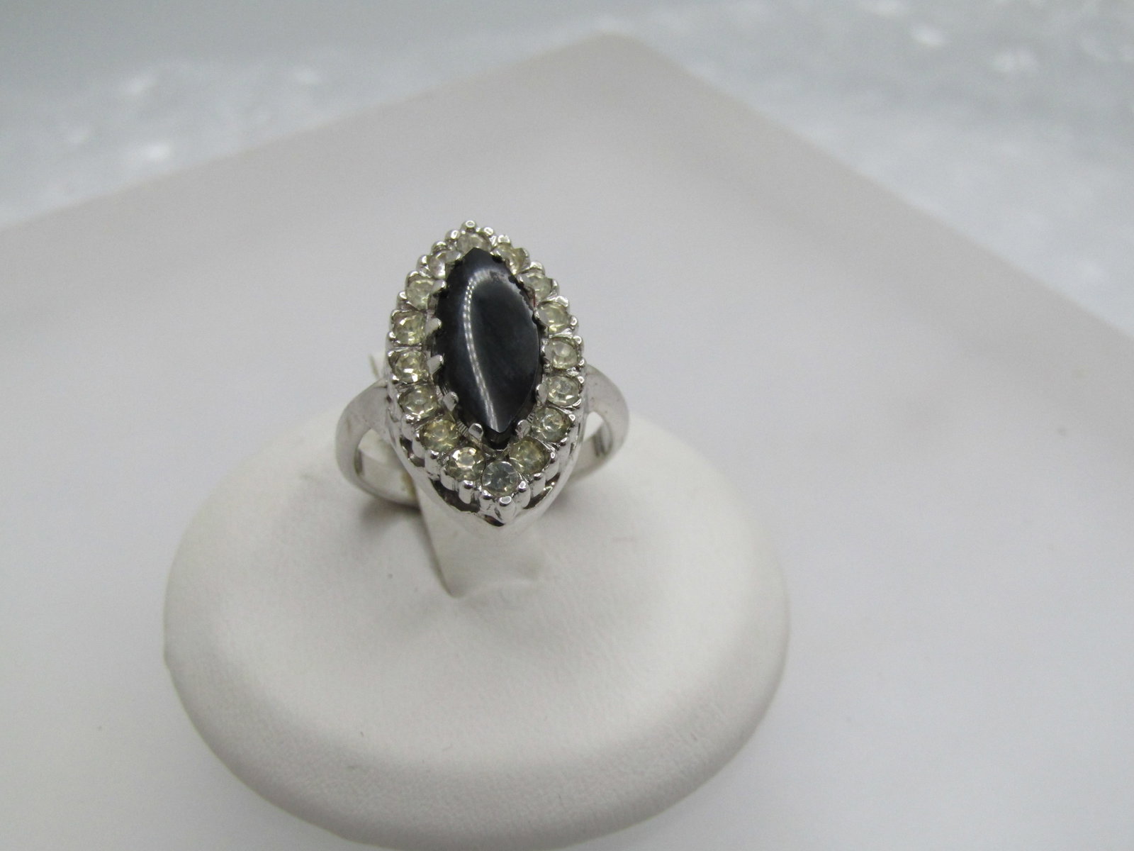 Vintage Black & Clear Rhinestone Ring, Marked Sterling, Sz. 4.5: Vintage Black & Clear Rhinestone Ring, Marked Sterling, Sz. 4.5. This has an 11mm by 5mm marquise black stone that is believed to be glass with a halo of clear rhinestones. The ring is also marquise s