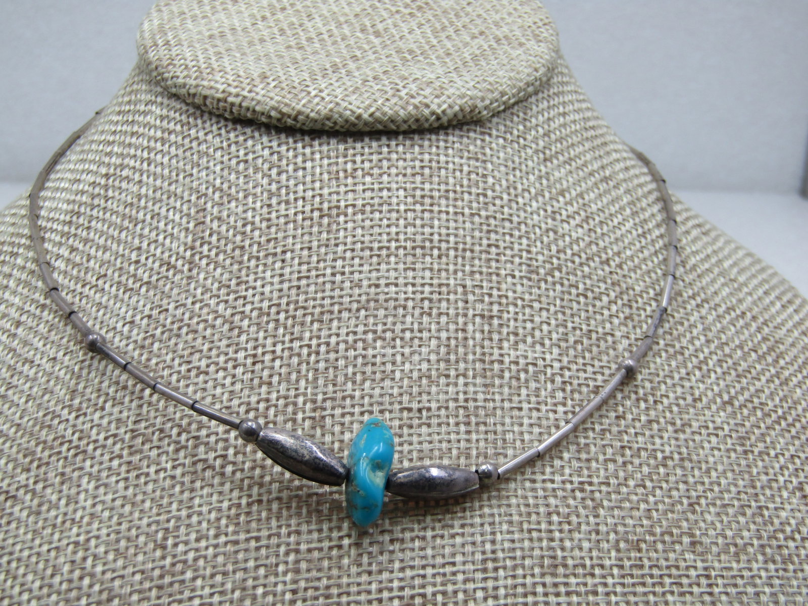 Vintage Sterling Southwestern Beaded Turquoise Necklace, 16": Vintage Sterling Southwestern Beaded Turquoise Necklace, 16" with hook clasp. Sterling straw beads with round accent beads and a puffy oblong bead on each side of the single turquoise nugget that is