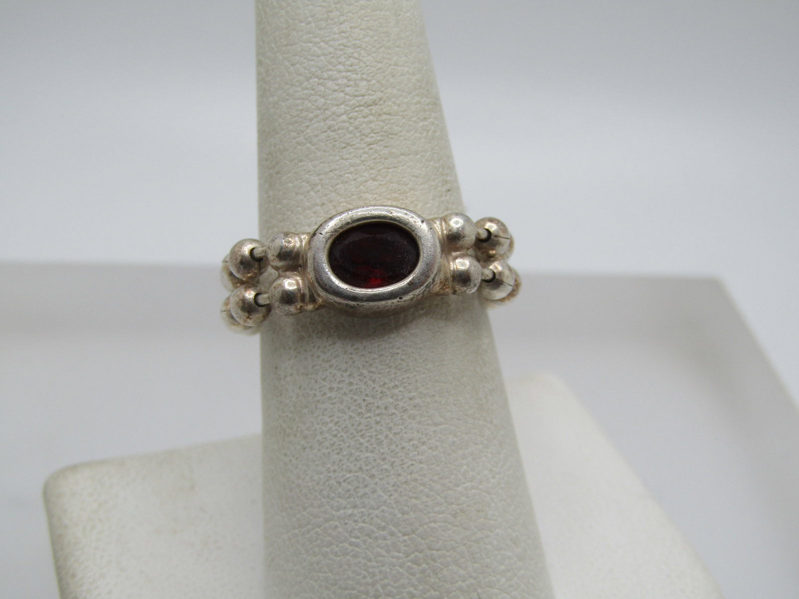 Vintage Sterling Garnet Chain Band Ring, Sz. 8.: Vintage Sterling Garnet Chain Band Ring, Sz. 8. trhis has a setting with a bezel around the garnet which is oval and appx. 8mm by 5.5mm. The band is two strands of beaded chain link (like a keychain s