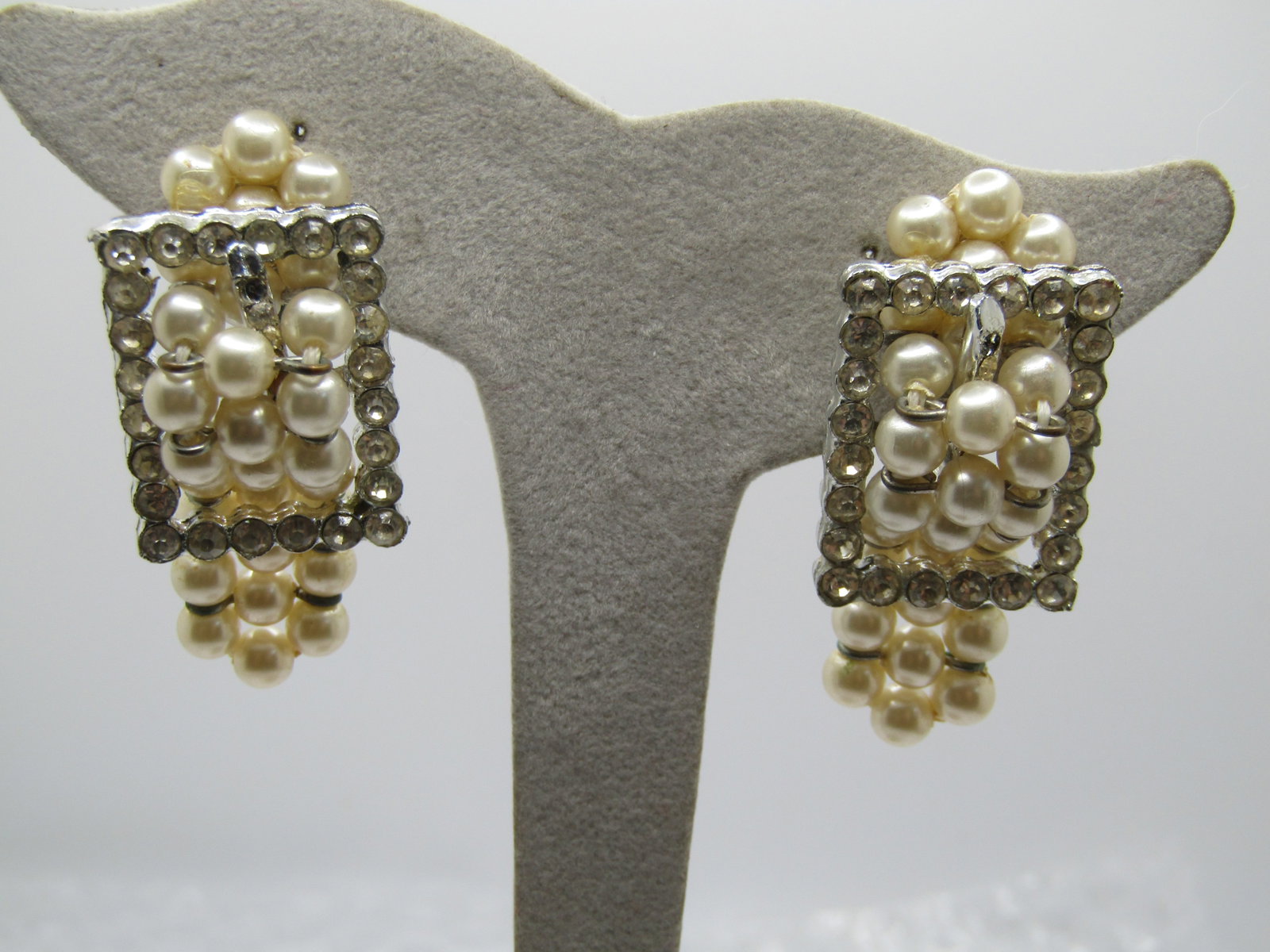 Vintage Faux Pearl & Rhinestone Belt Earrings, Clip, 1940's: Vintage Faux Pearl & Rhinestone Belt Earrings, Clip, 1940's. Silver tone earrings with a clear rhinestone belt buckle and a triple srand faux pearl belt that dangles from below the buckle and through
