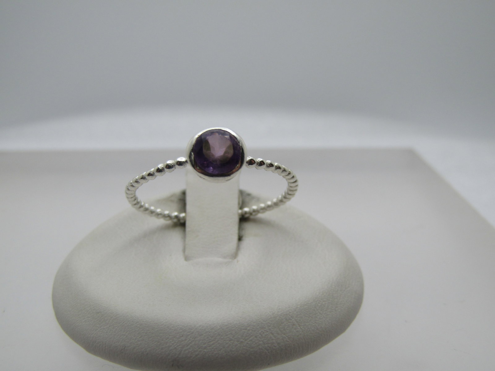 Sterling Amethyst Ring, Size 9.5, Bezel-Set: Sterling Amethyst Ring, Size 9.5, Bezel-Set. Modern ring, likely 2000 or after, unworn. It has a band that is appx. 1.3mm wide that looks like it is made of connected silver beads. The amethyst is app