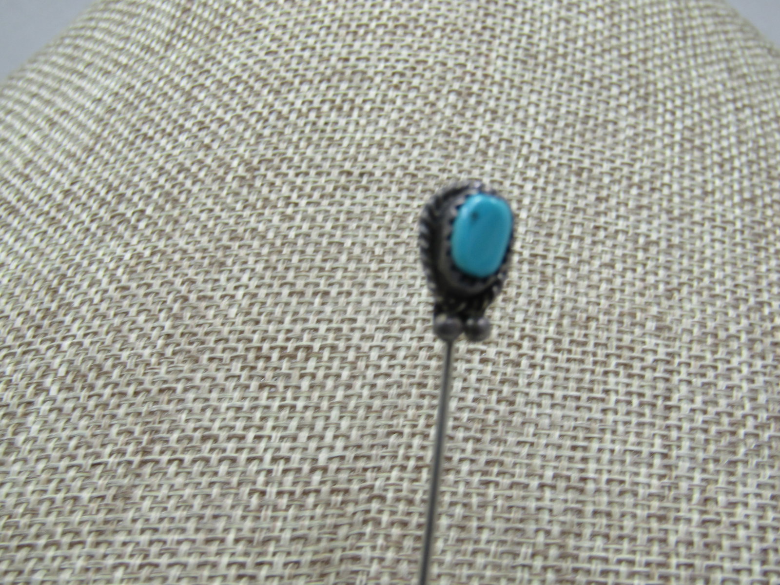 Vintage Sterling Southwestern Turquoise Stick Pin, 2.75": Vintage Sterling Southwestern Turquoise Stick Pin, 2.75". The topper has a bezel set 6.5mm by 4.5mm Turquoise stone, oval shaped. Sawtooth bzel. Raised with a rope accent and beaded accent. The