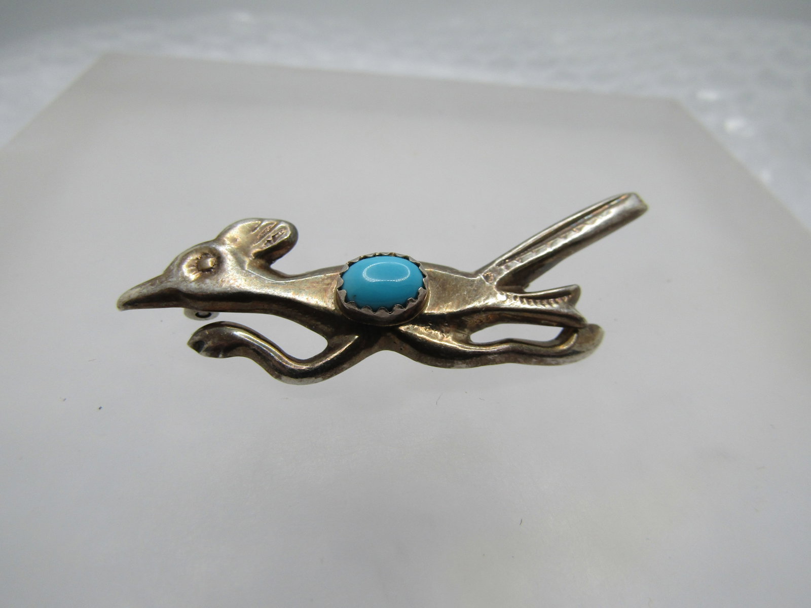 Vintage Sterling Southwestern Turquoise Roadrunner Brooch, 1960's-1970's. 2": Vintage Sterling Southwestern Turquoise Roadrunner Brooch, 1960's-1970's. 2" wide and 1" tall at the tall to the feet. It has an oval sleeping beauty sawtooth bezel-set turquoise stone that is appx. 7
