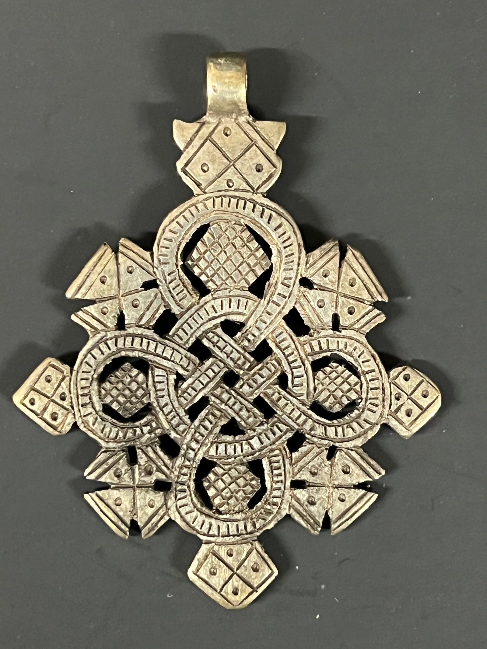 Ethiopian Metal Cross Pendant: Title: Ethiopian Metal Cross Pendant Description: Ethiopian Metal Cross Pendant Date/Period: Late 20th Century Materials: Metal Size: 2" h x 2" w Reserve: $40.00 Shipping: Domestic: Flat-rate of