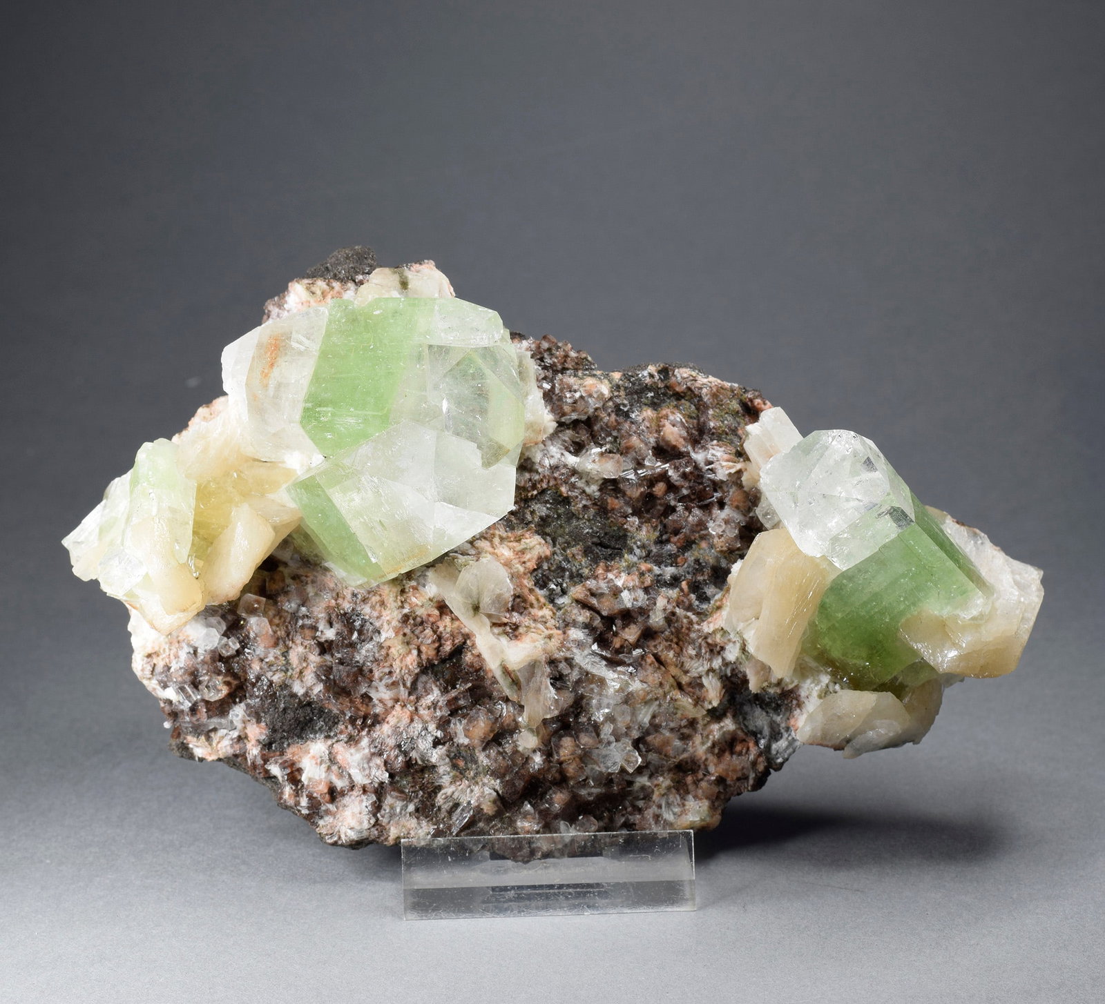 Crystals of Apophyllite, calcite and heulandite on trap matrix: Title: Crystals of Apophyllite, calcite and heulandite on trap matrix Origin: India Size: c. 14 x 8.5 cm Description: Crystals of Apophyllite, calcite and heulandite on trap matrix. Beautiful color an