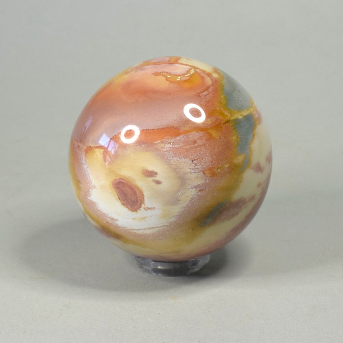 5.3 cm Polished Polychrome Jasper sphere: Title: 5.3 cm Polished Polychrome Jasper sphere Origin: Madagascar Size: 5.3 cm diameter Description: Species: Polychrome Jasper Locality: Madagascar Diameter: 5.3 cm Weight: 0.2 kg Fine polished ocea