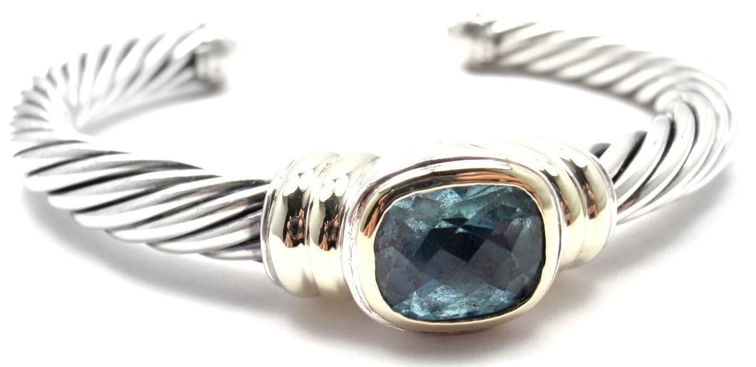 Authentic! D.Yurman NOBLESSE 14k YG Sterling Silver Blue Topaz Bangle Bracelet: Authentic! D.Yurman NOBLESSE 14k YG Sterling Silver Blue Topaz Bangle Bracelet About This Piece: Metal: 18k Yellow Gold & Sterling Silver Length: 7" Weight: 48.9 grams Width: 6.5mm Hallmarks: D.Y. 585