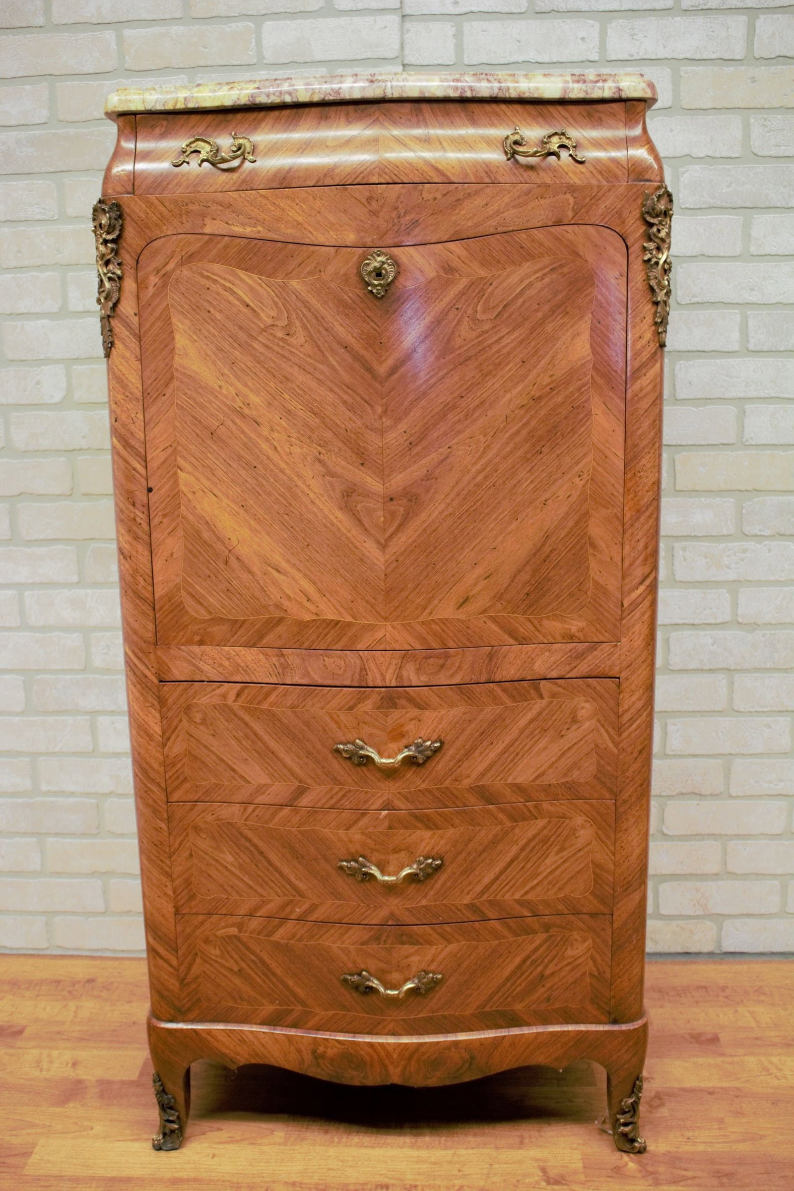 Antique French Louis XV Style Marquetry Flip Down Secretary Writing Chest with Marble Top: Materials: marble, wood, brass, maple, bronzeWidth: 33 inchesHeight: 55 inchesDepth: 17 inchesAntique French Louis XV Style Marquetry Flip Down Secretary Writing Chest with Marble TopAn exceptional