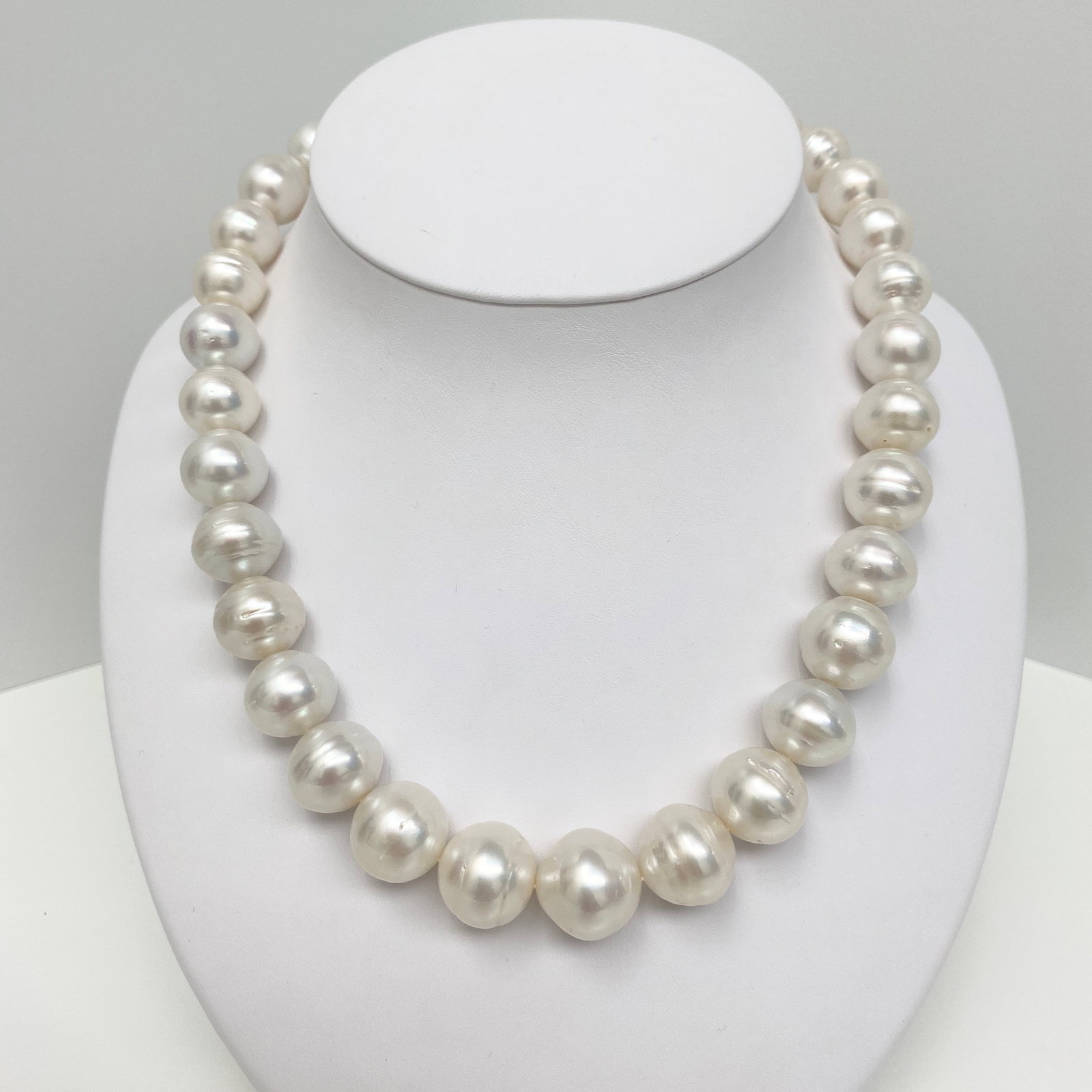 14-17mm South Sea White Circled Button Pearl Necklace with 14k Clasp: Title:14-17mm South Sea White Circled Button Pearl Necklace with 14k Clasp Description:AAA Luster, White South Sea Circled Button Pearl Necklace, 29 pearl pieces, 18 inches hand-knotted with 14k YG