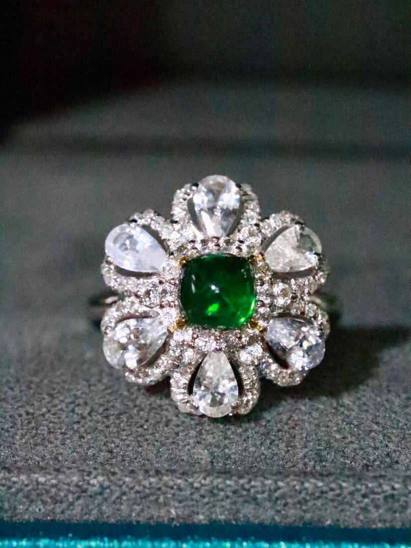 18K Gold Natural Tsavorite Ring: Title: 18K Gold Natural Tsavorite Ring Description: This ring blooms like a flower on your finger, dazzling and captivating. The green brilliance of the tsavorite complements the sparkle of the