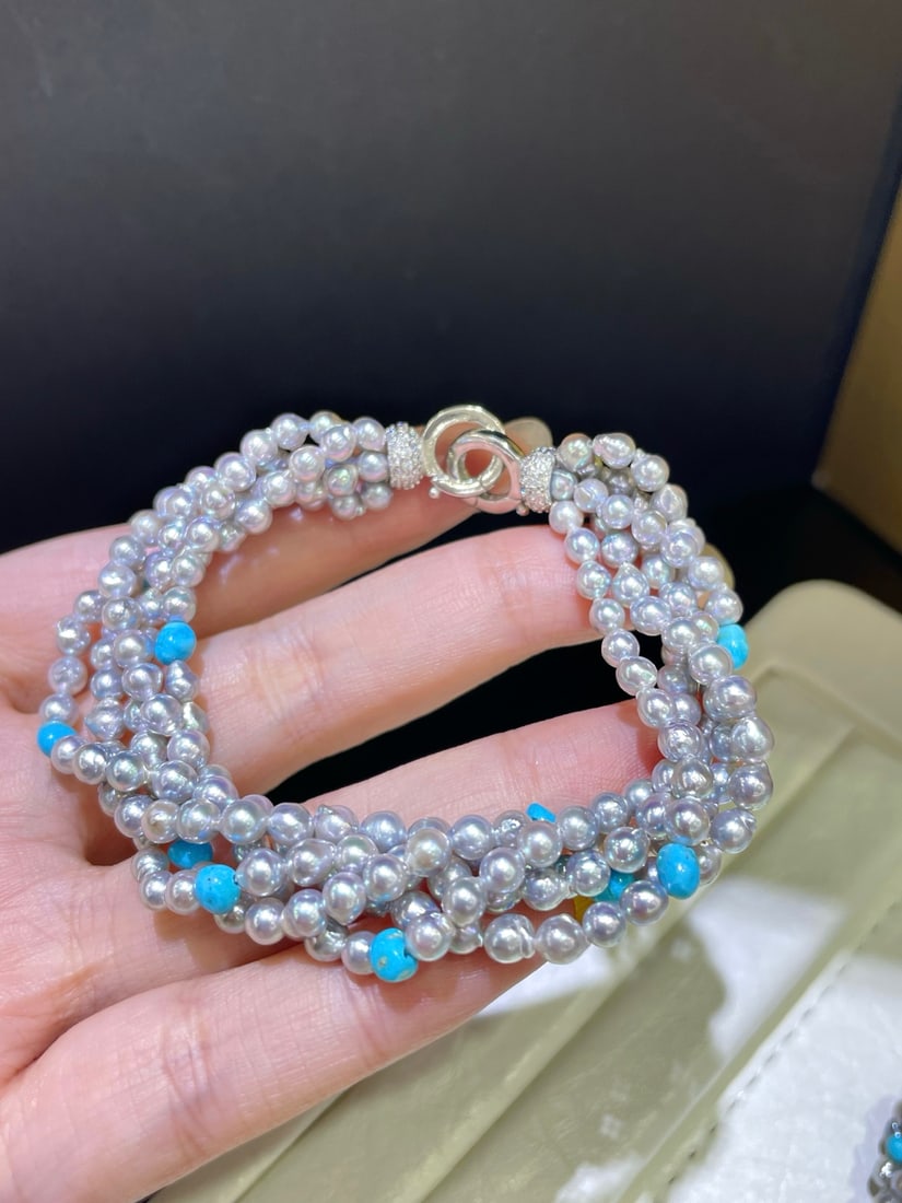 Freshwater Pearl Bracelet: Title: Freshwater Pearl Bracelet Description: This bracelet embodies the elegance of a classical beauty with its multi-layer design, featuring pearls with a silver-blue aurora hue and rich overtones.